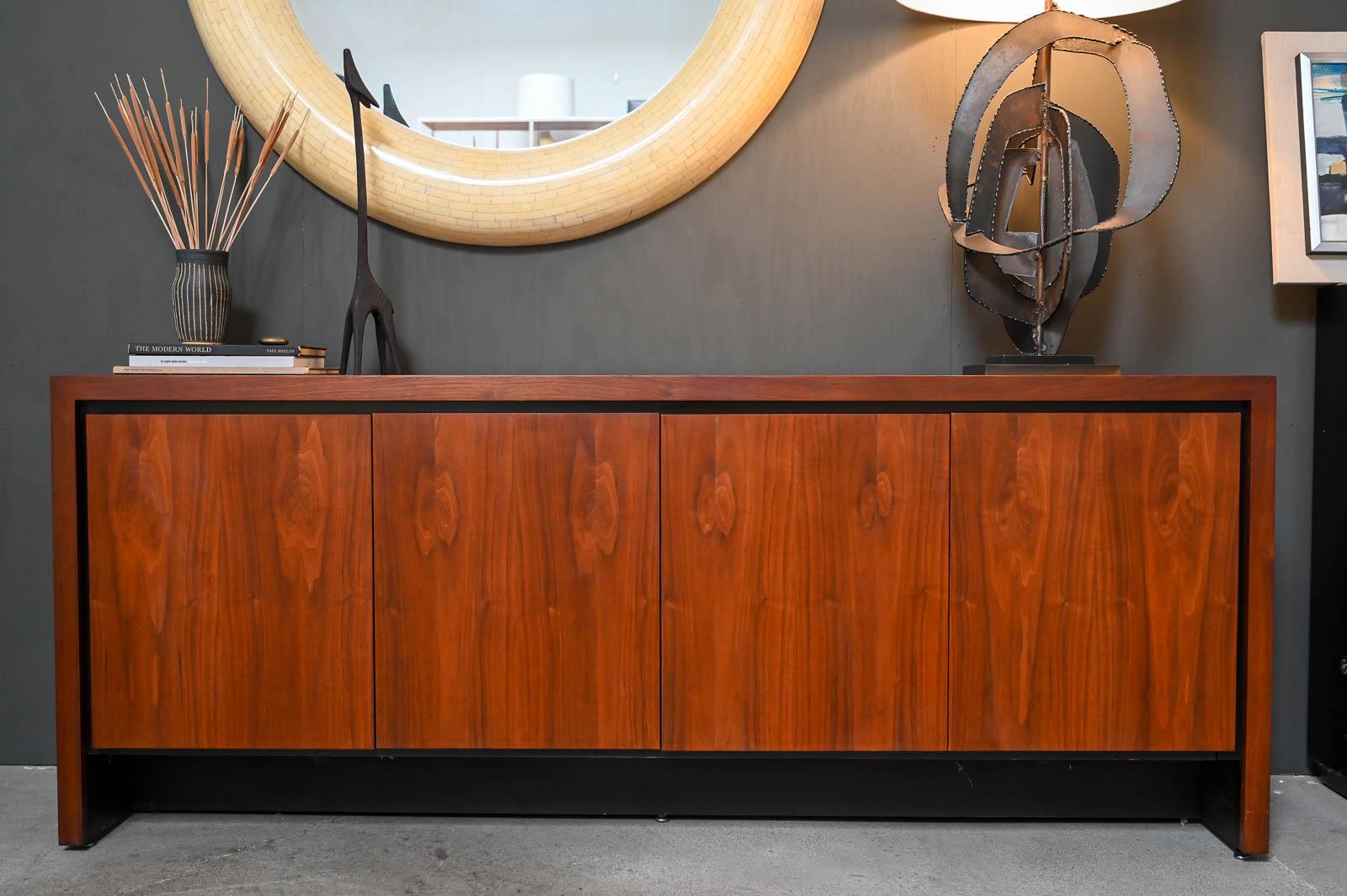 Walnut Credenza by Merton Gershun for Dillingham, ca. 1970.  Beautiful American Black Walnut with hinged doors and two inner drawers with adjustable shelving.  In beautiful original vintage condition, this piece has hardly any wear and is a 9/10