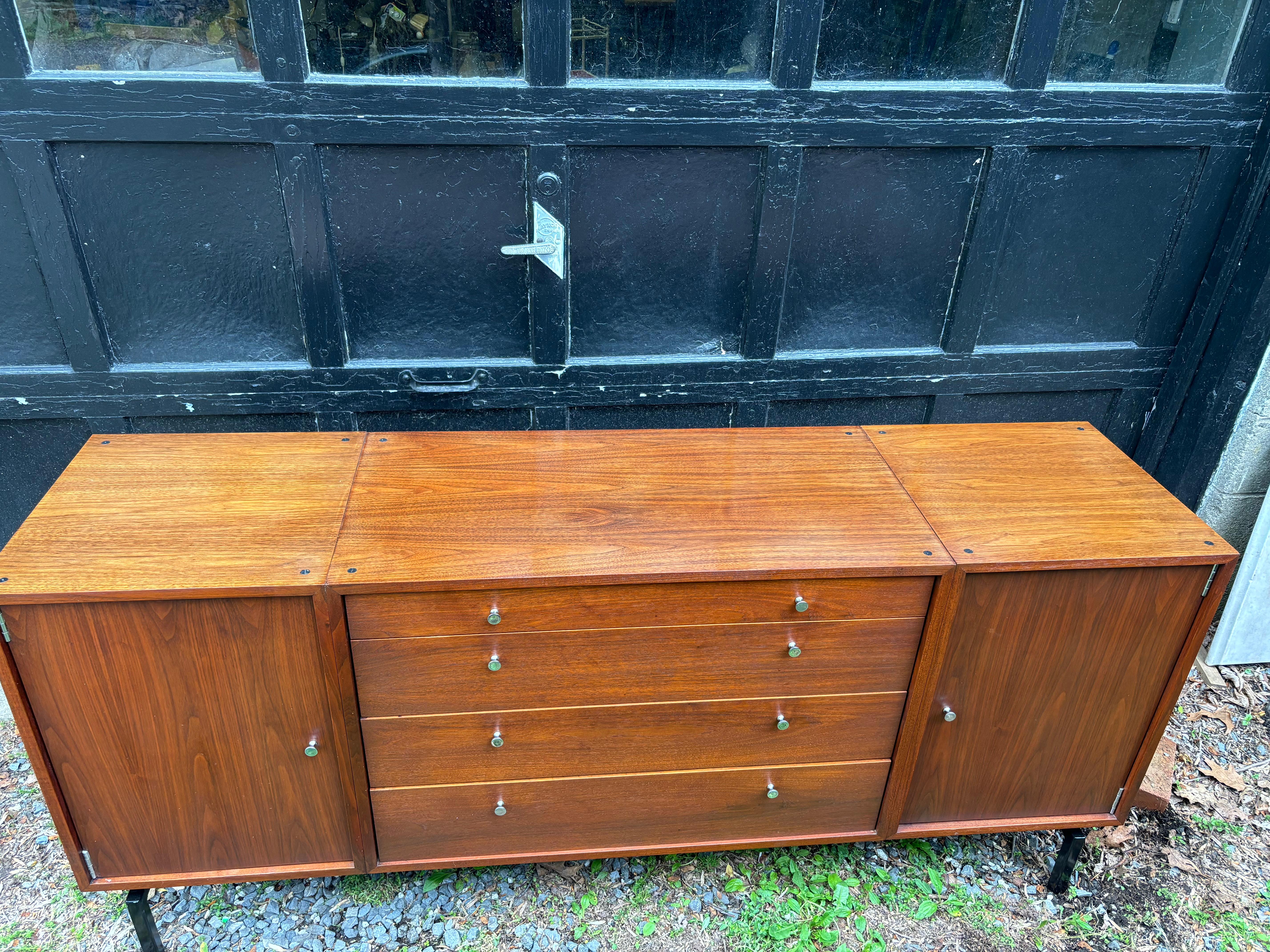Walnut Credenza or Buffet that sits up on a square iron black base.  Two doors and 4 drawers for plenty of storage!  Unique system of connecting cabinets together to create the configuration desired.  Not sure who the maker is and have not seen