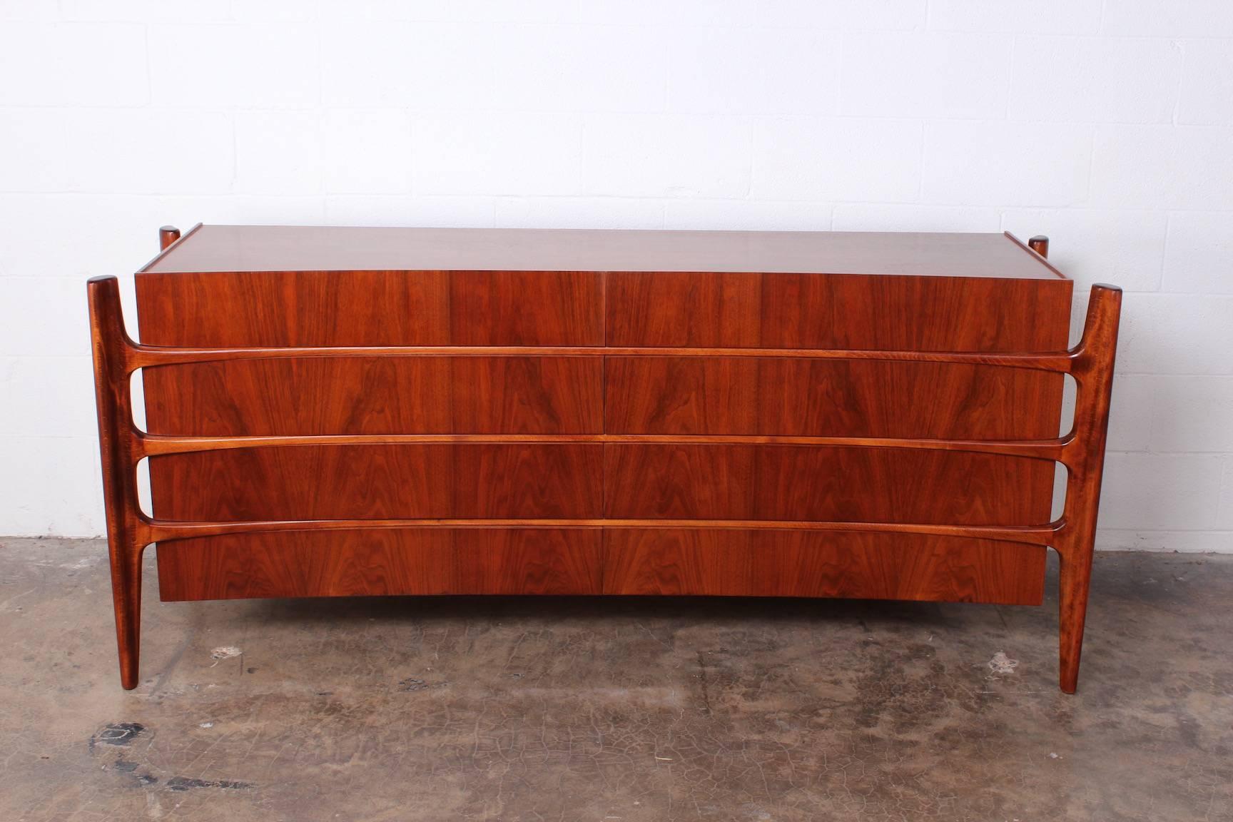 A sculptural walnut eight-drawer dresser designed by William Hinn and made in Sweden by Swedish furniture guild for Urban Furniture.