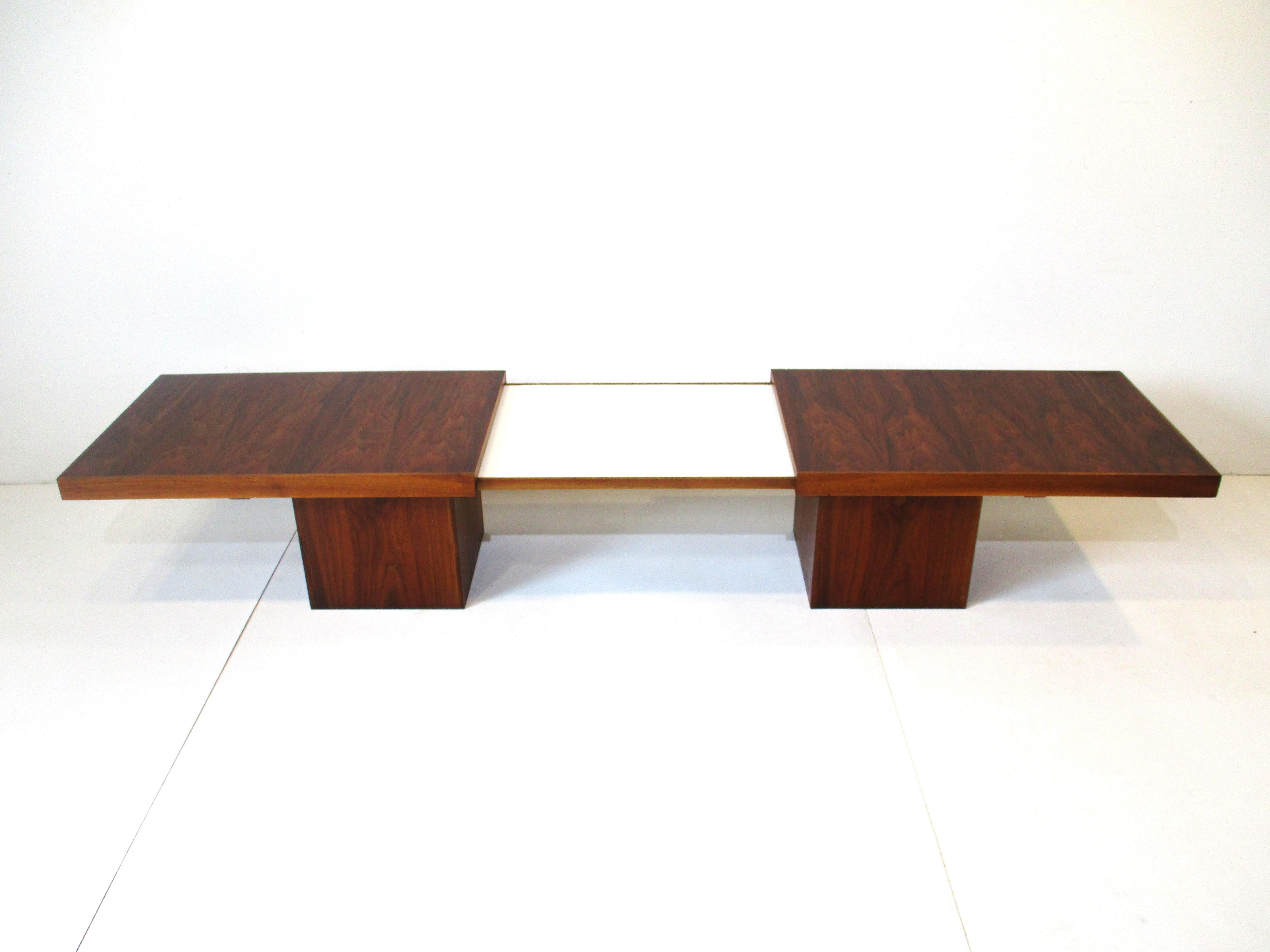 A rich medium dark walnut coffee table that expands to 82 .5 