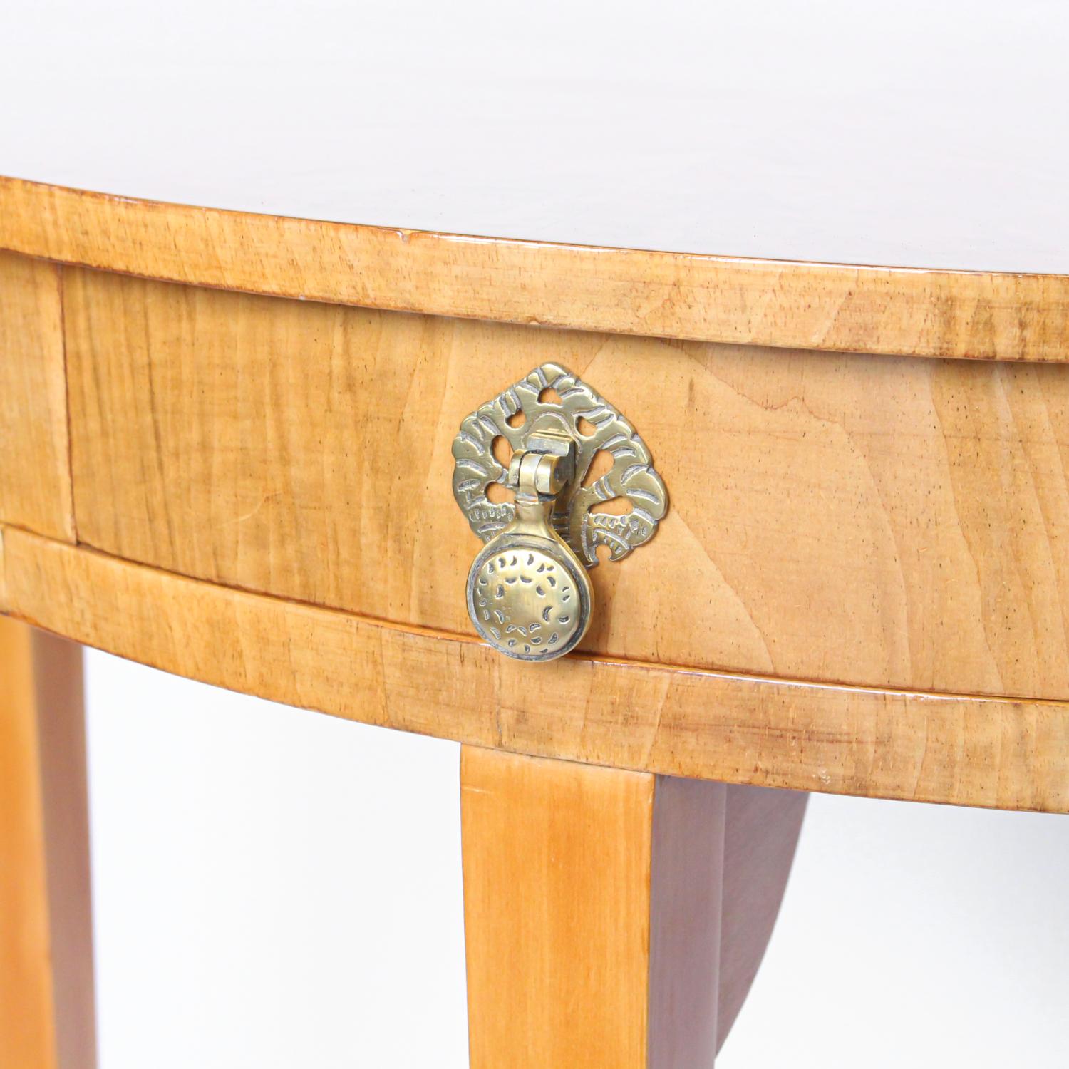 An Art Deco, walnut demi-lune console table with integral drawer. Original brass handle.

Origin: English 

Date: circa 1935