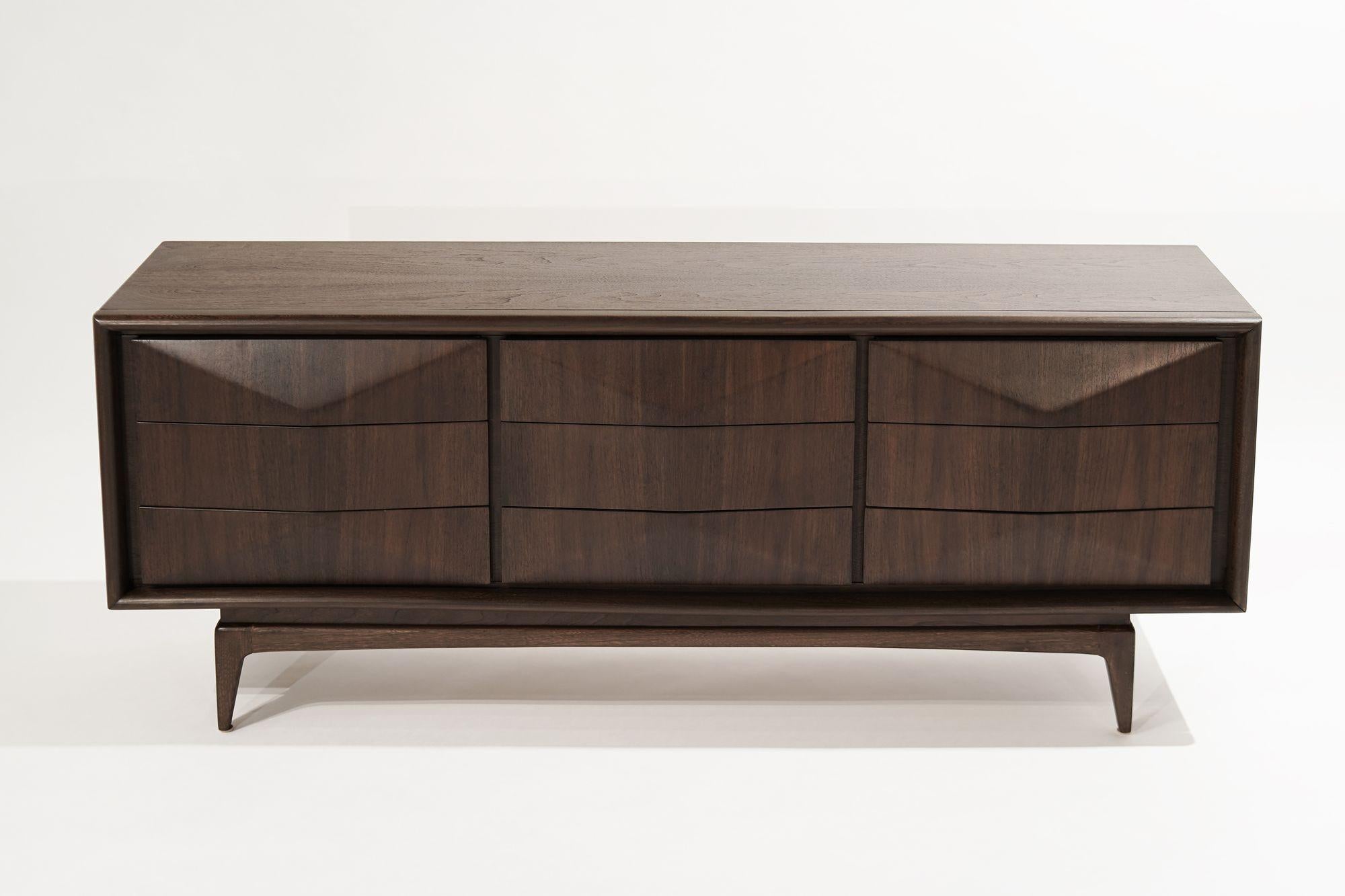 A stunning dresser executed in walnut, circa 1950-1959 by United Furniture. Bookmatched drawer faces mimic a diamond shape. Completely restored.
 
Other designers from this period include Paul McCobb, Vladimir Kagan, Hans Wegner, Gio Ponti, and