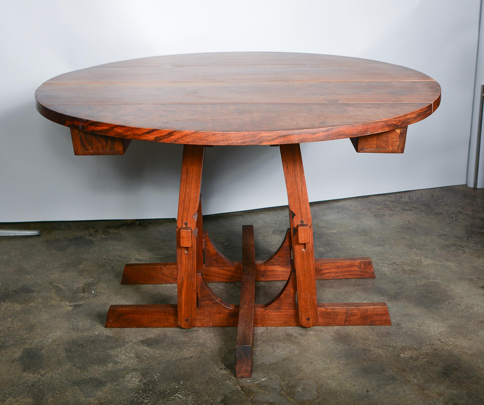 Solid walnut dining table by furniture designer and maker Morris Sheppard. This table expands up to 8 feet with four leaves. We believe this was a custom design for the clients as the table also lowers to 17 5/8 inches in height. The legs have a
