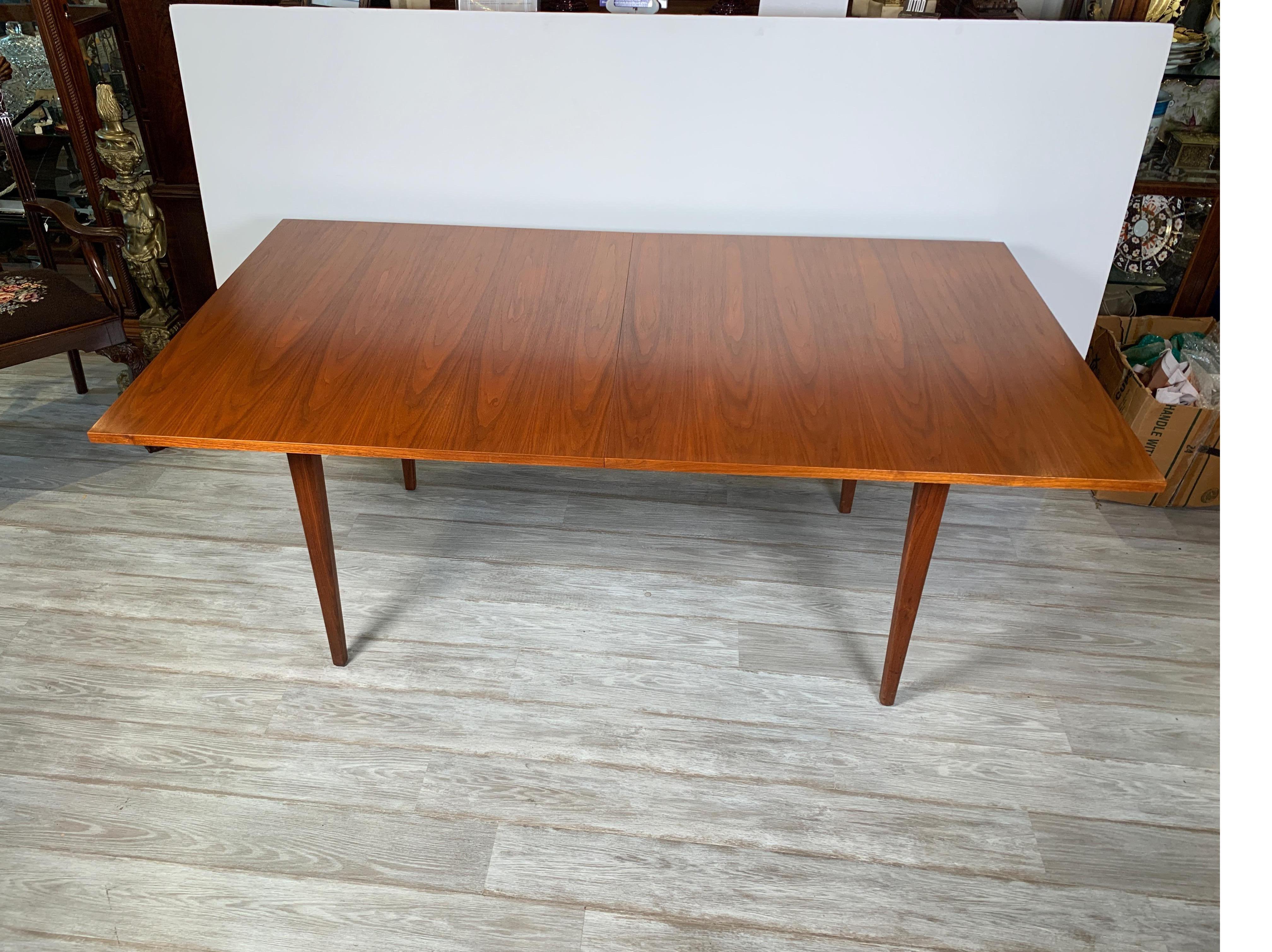Uncommon and gorgeous walnut dining table by George Nelson for Herman Miller, USA, 1955. In beautiful original condition with minor signs of well-cared-for use. The table is 72