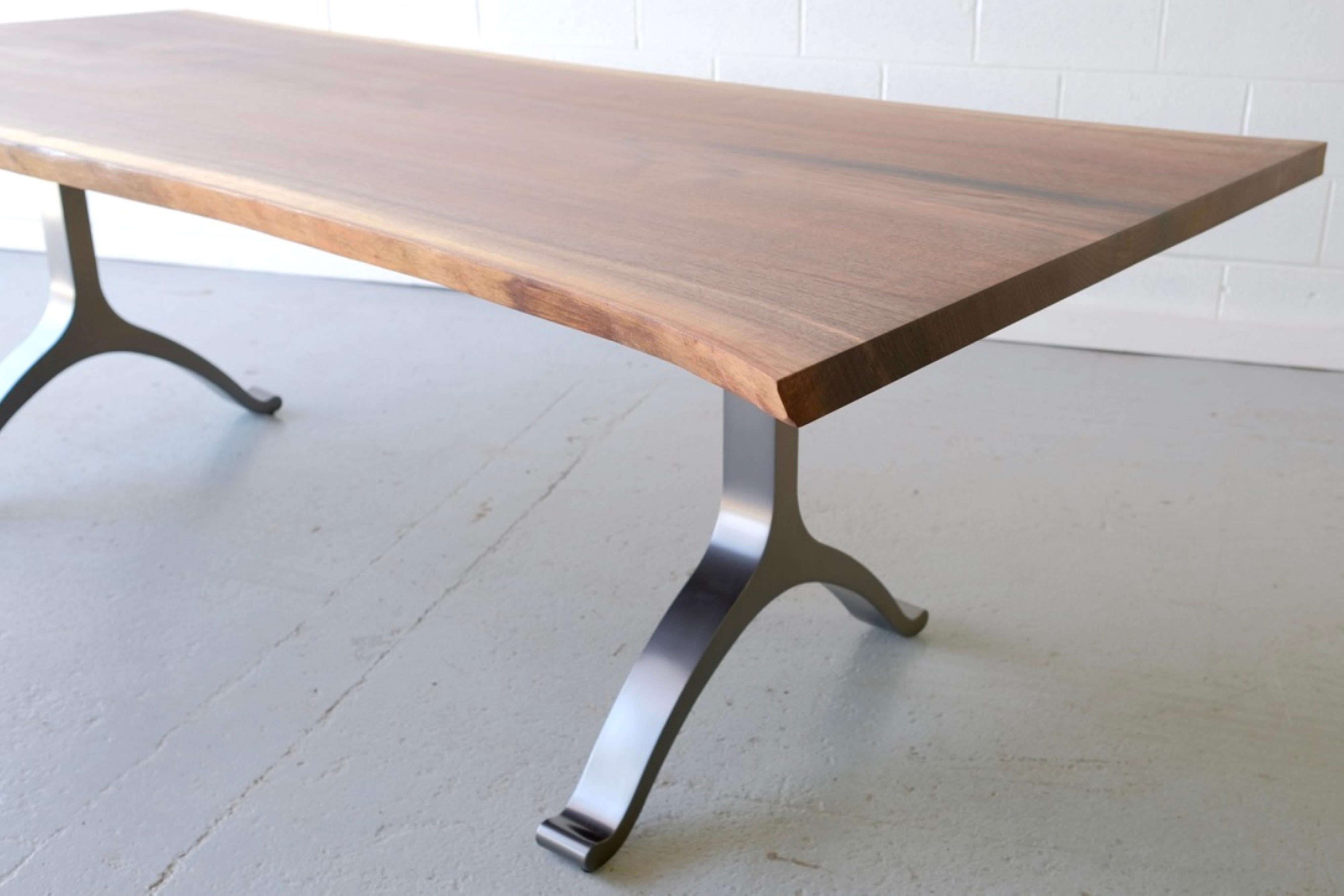 Heirloom quality, this dining table is handmade from a single slab of solid walnut and features a beautiful grain. The Wishbone legs set of the solid wood top.

Handcrafted by our skilled team, you can be sure that your new table will be one of a