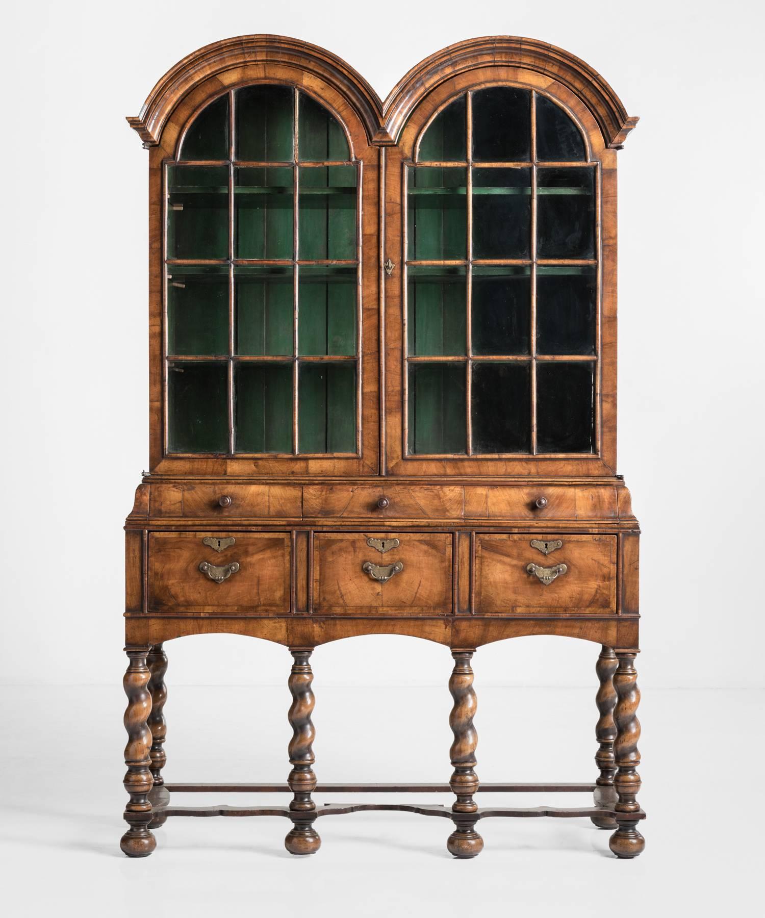 Walnut display cabinet, circa 1890.

Elegant cabinet in the William & Mary Style, with unique twin domed top, turned legs, and striking green painted pine interior.
 