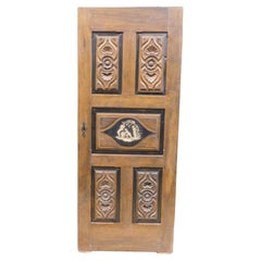 Walnut door, for interiors, both lacquered and carved, Italy