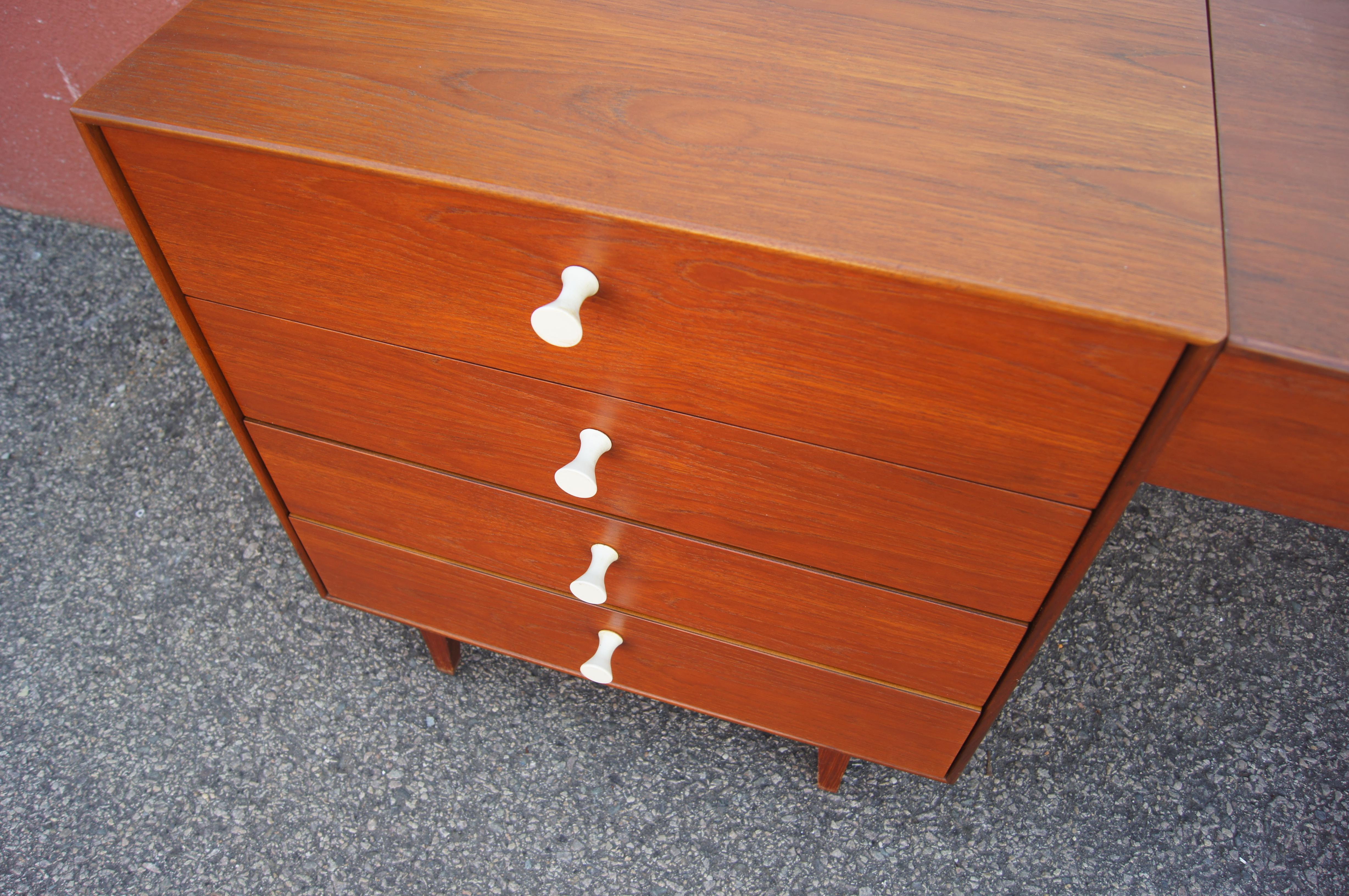 Part of the Thin Edge series that George Nelson designed for Herman Miller in the 1950s, this wonderful set comprises two dressers in a tawny walnut on either side of a suspended vanity.

The dresser to the left, model 4701, is 24 inches wide and