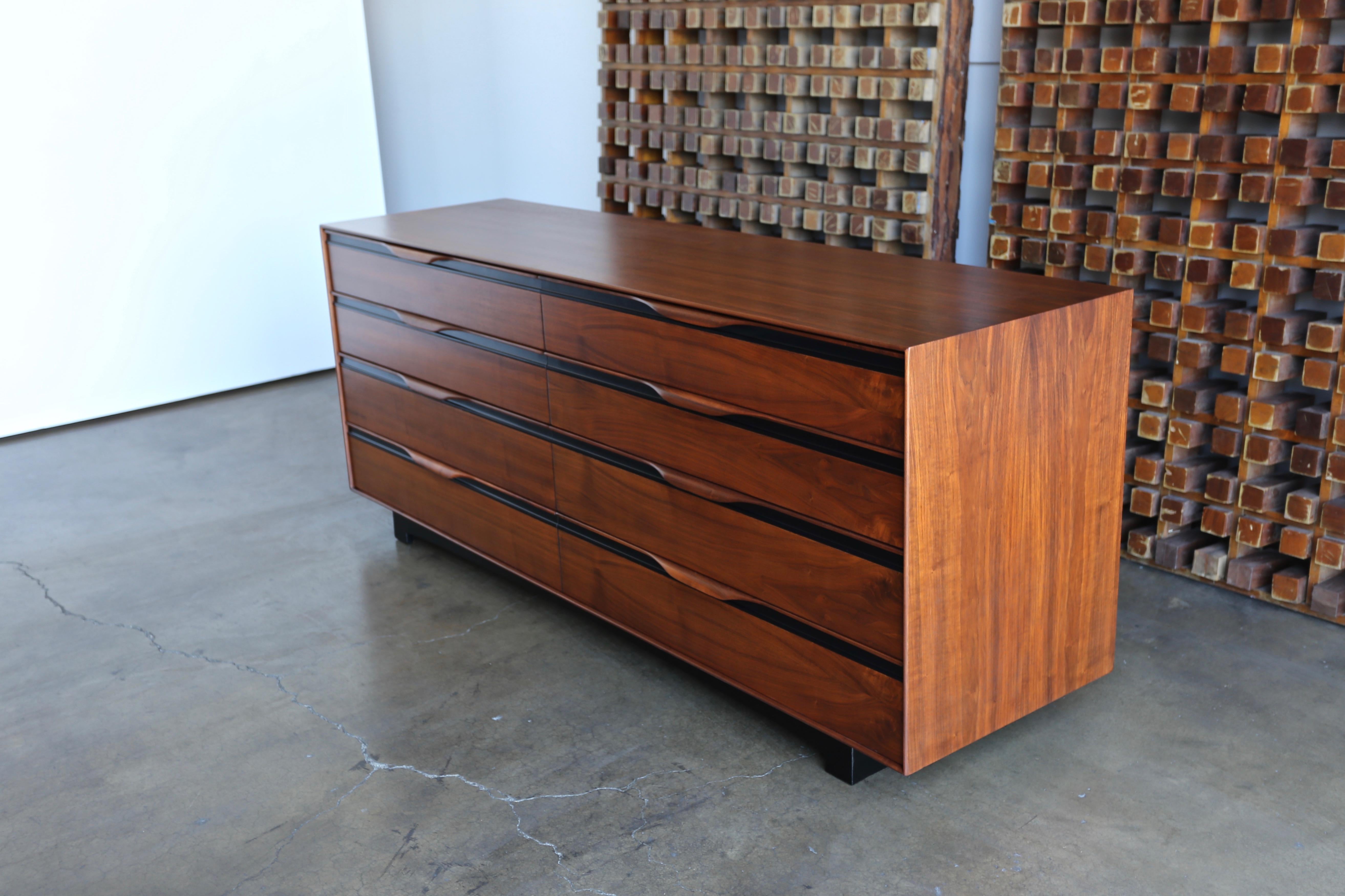 Walnut eight-drawer dresser by John Kapel for Glenn of California. This piece has been professionally restored.