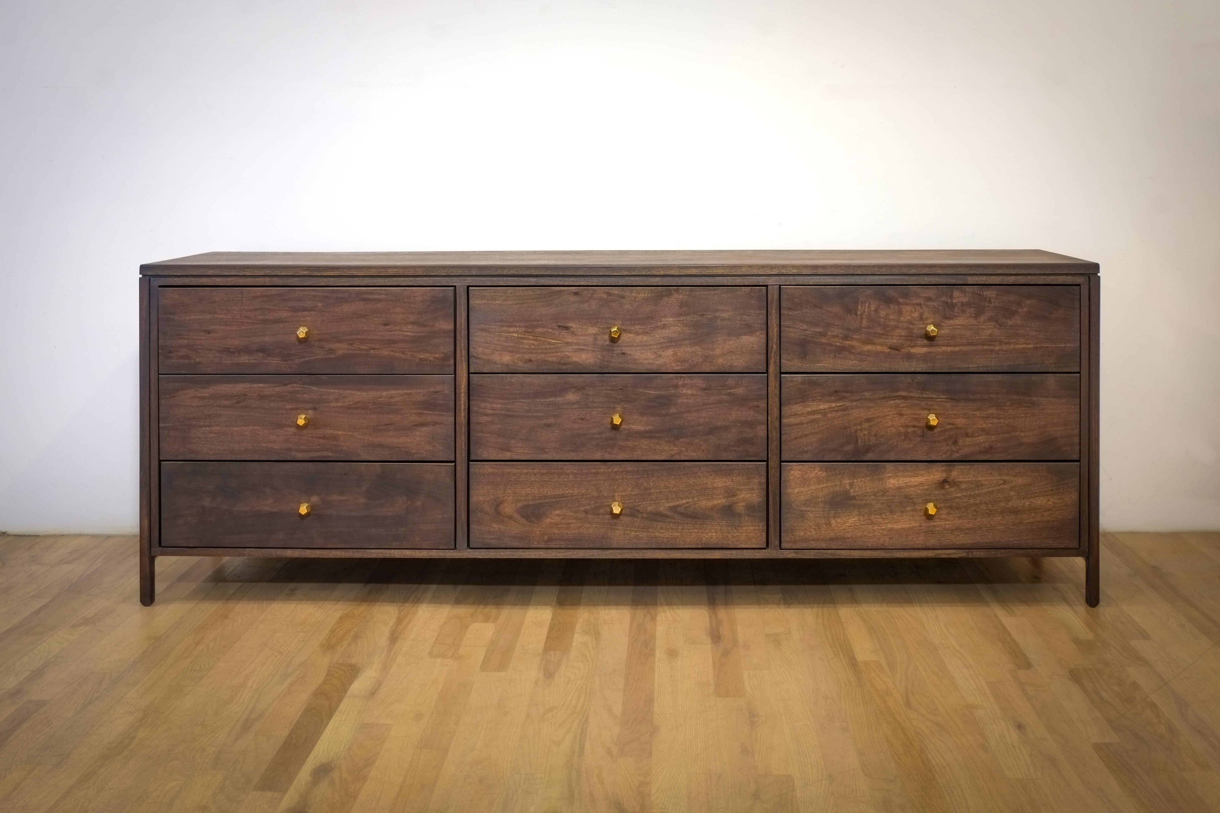 The Boston Dresser is a double book-matched piece with luscious drawers in dark walnut. Round over void edges with a cantilevered belly on slender legs. 
Mostly constructed in solid walnut this piece will be a heavyweight in whatever setting you