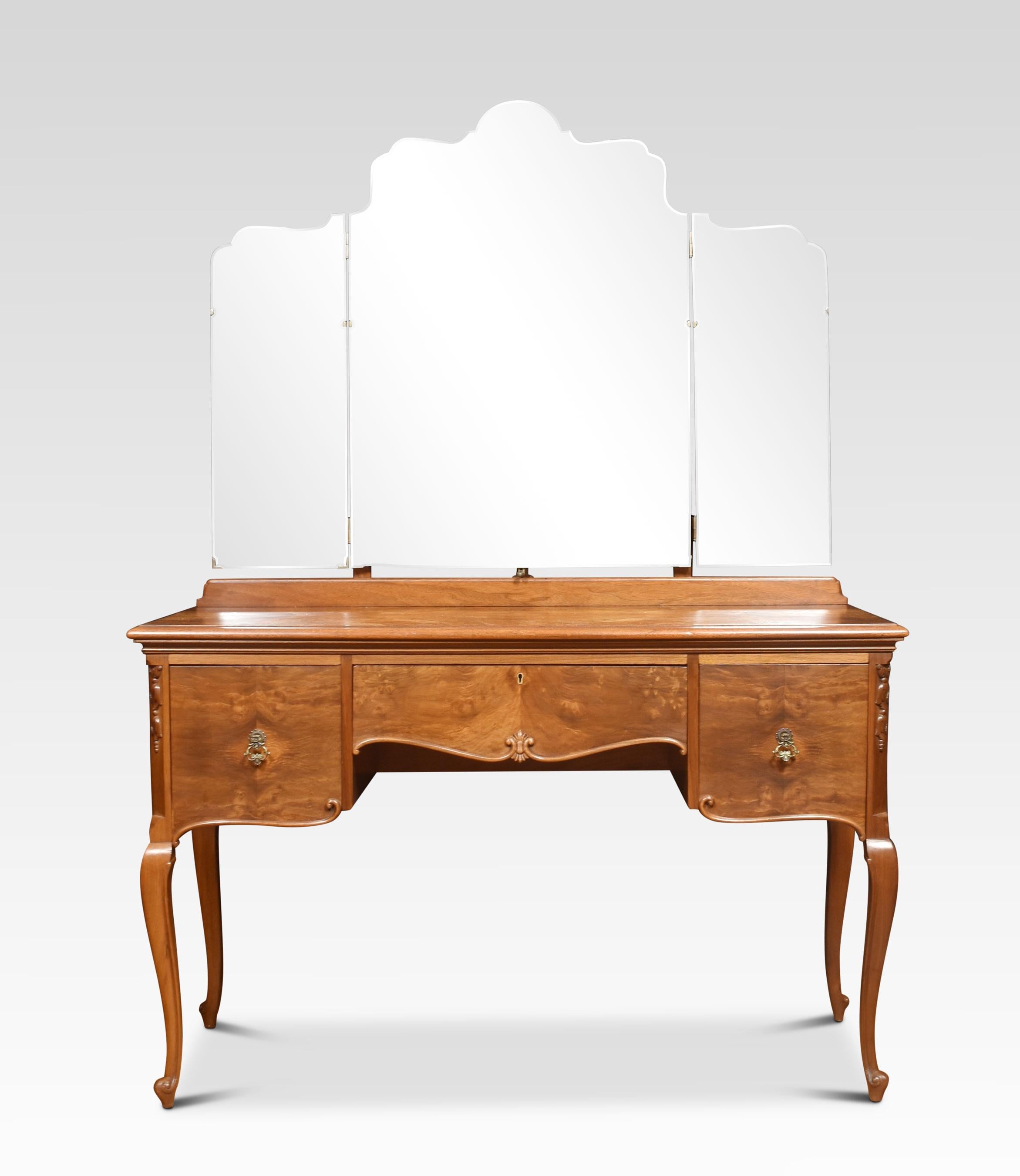 Walnut dressing table, the impressive superstructure consisting of a large central bevelled mirror and smaller mirrors to either side. The rectangular well figured walnut top with moulded edge, over an arrangement of drawers, having brass drop