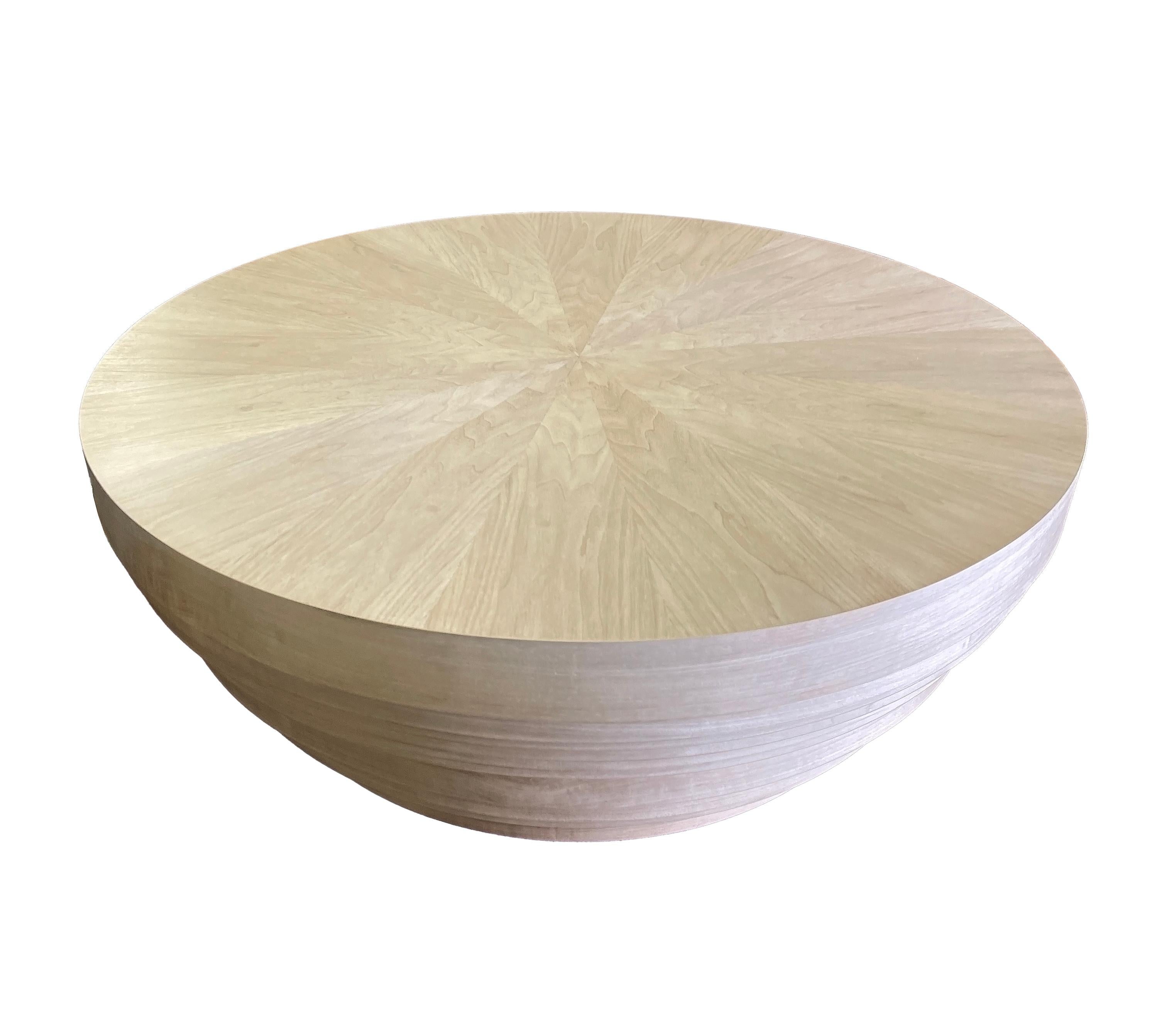 The iconic tribal Jaya drum table is handcrafted with traditional joinery, fabricated with multiple stacked discs in various sizes, toped with a book-matched sunburst, the Drum table is finished with a lustrous polish. Custom sizes and finishes