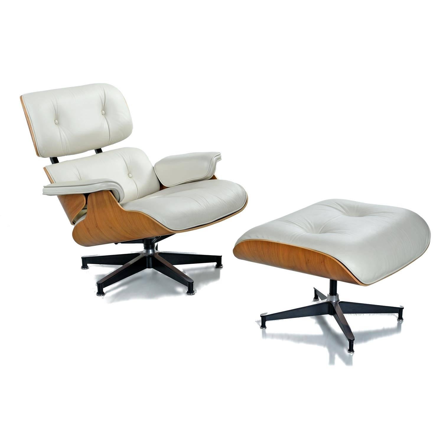 Iconic Mid-Century Modern Herman Miller Eames chair. Ivory genuine leather with walnut shell. Reclining chair comes with matching ottoman. Approximately 10 years old. Chair saw little use and shows no notable wear. Herman Miller label present