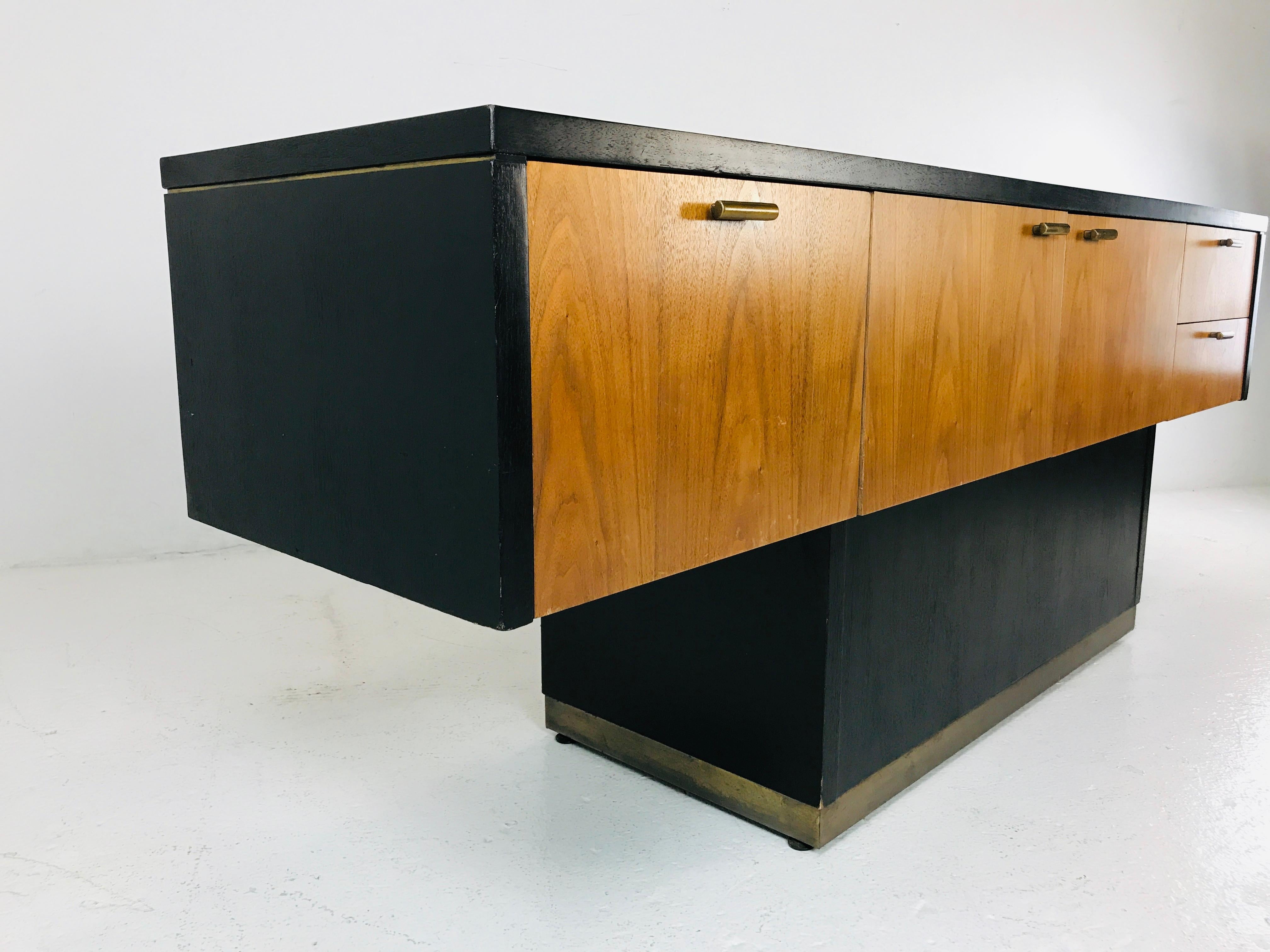 Cantilever credenza with brass plinth and brass accents. Great as office stage or to anchor your television.