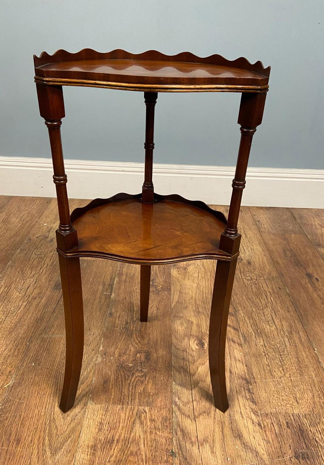 You are viewing a gorgeous Edwardian walnut side or tea table
A charming two-tier mahogany side table featuring beautifully shaped scalloped gallery edges to both the upper and lower shelves
The table is crafted in a warm, rich mahogany with