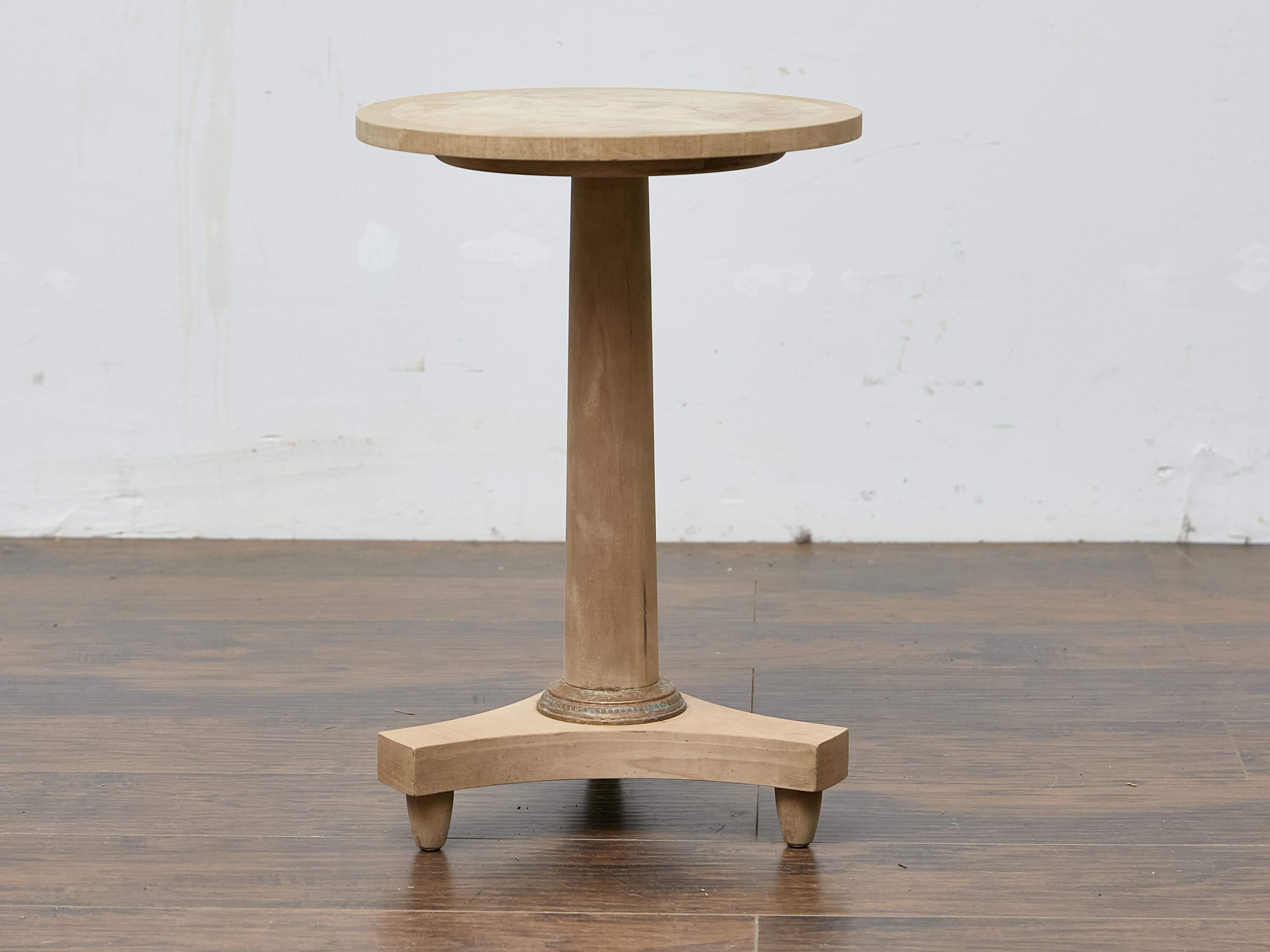 This early 20th-century French guéridon exemplifies the elegant simplicity of classical revival design. Crafted circa 1900, the piece is executed in solid walnut, which has been bleached to a pale, natural tone, softening the classical lines of the