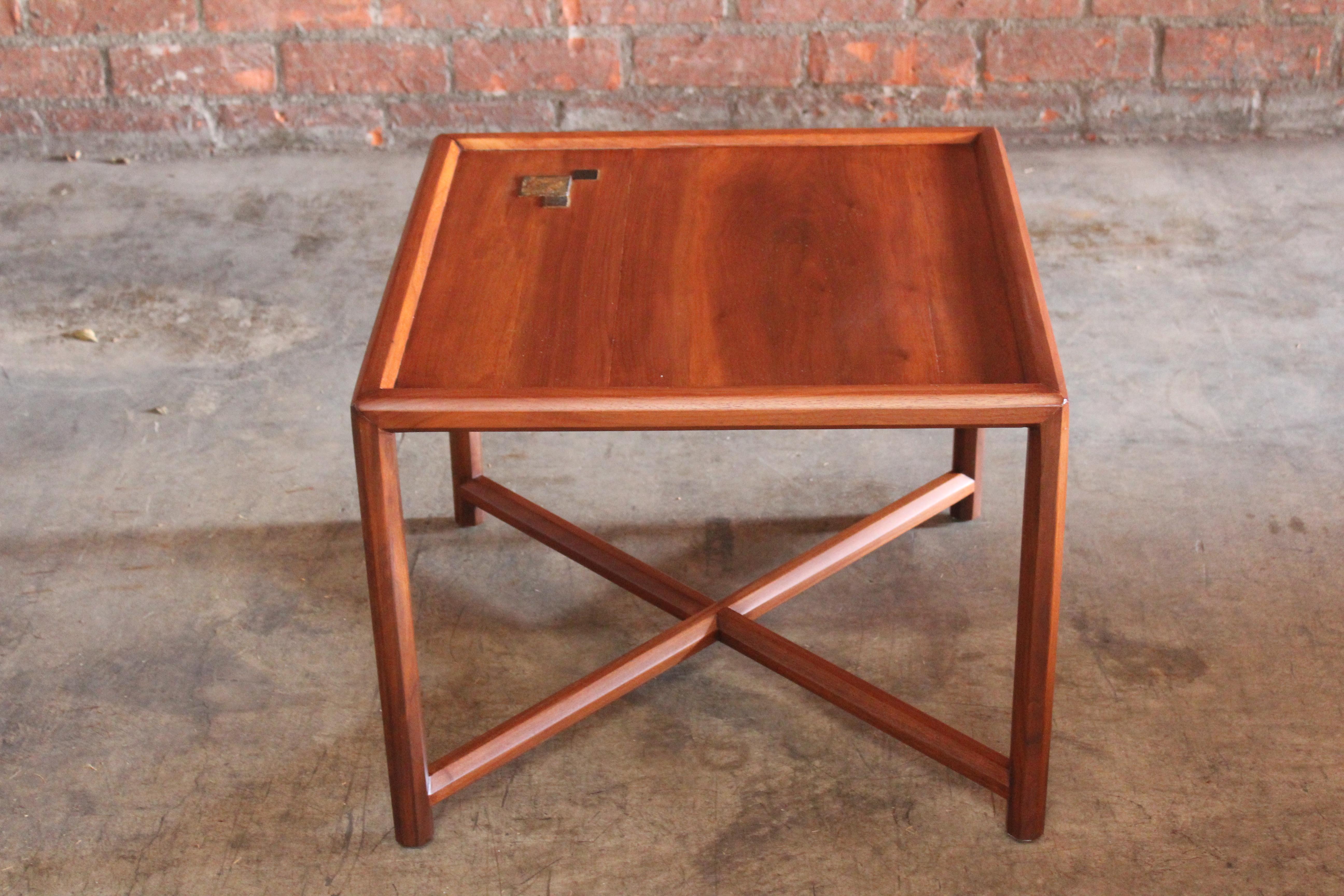 A solid walnut end table designed by Edward Wormley for the Janus Collection by Dunbar, 1957. Features Tiffany glass inlaid tiles. The table has been recently refinished and is in excellent condition.