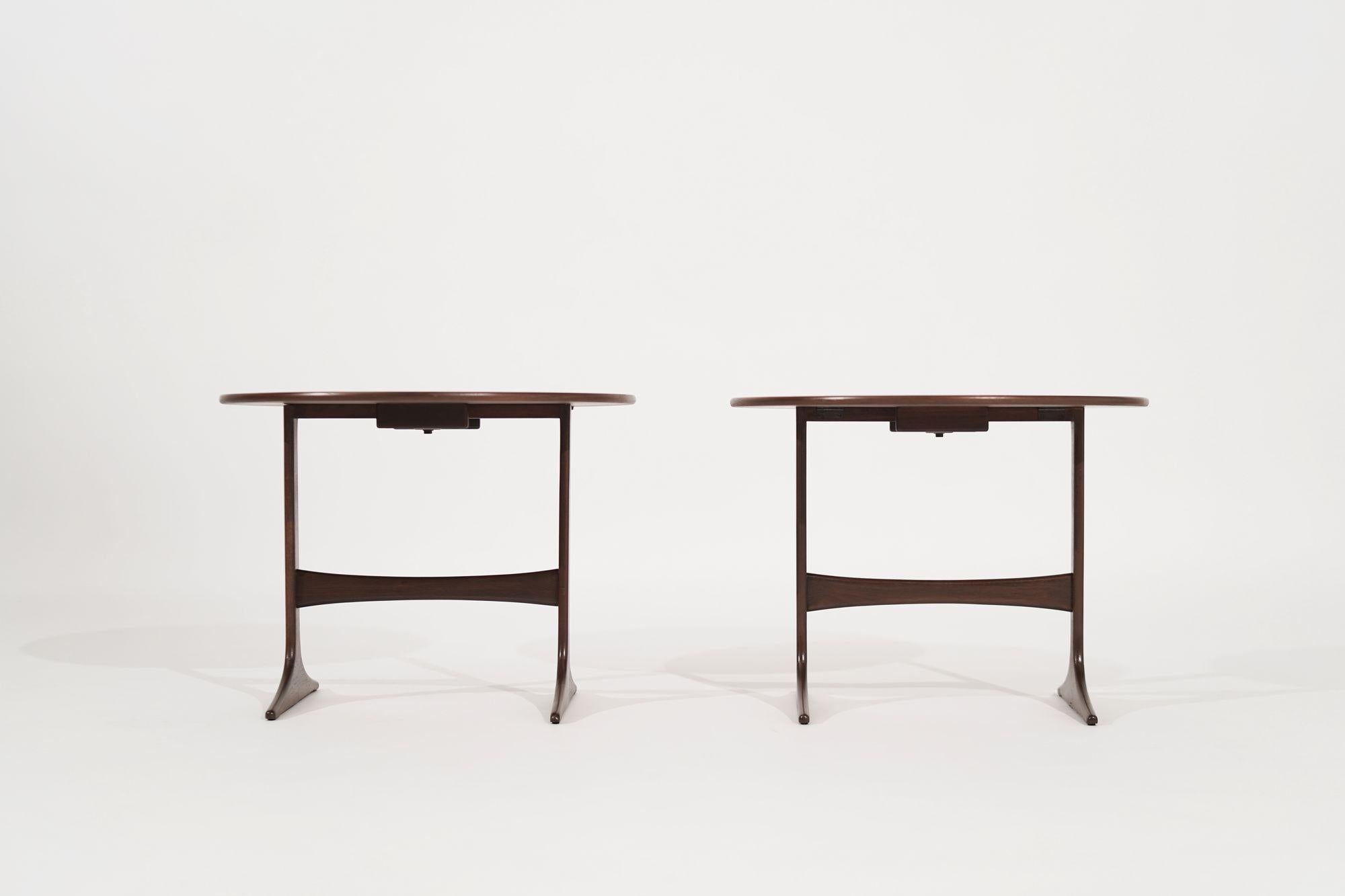 A stunning pair of walnut end tables designed by the renowned Sven Engstrom & Gunnar Myrstrand, fully restored from the 1960s to their original beauty. The tables feature a rich and warm walnut wood finish that radiates a timeless elegance and