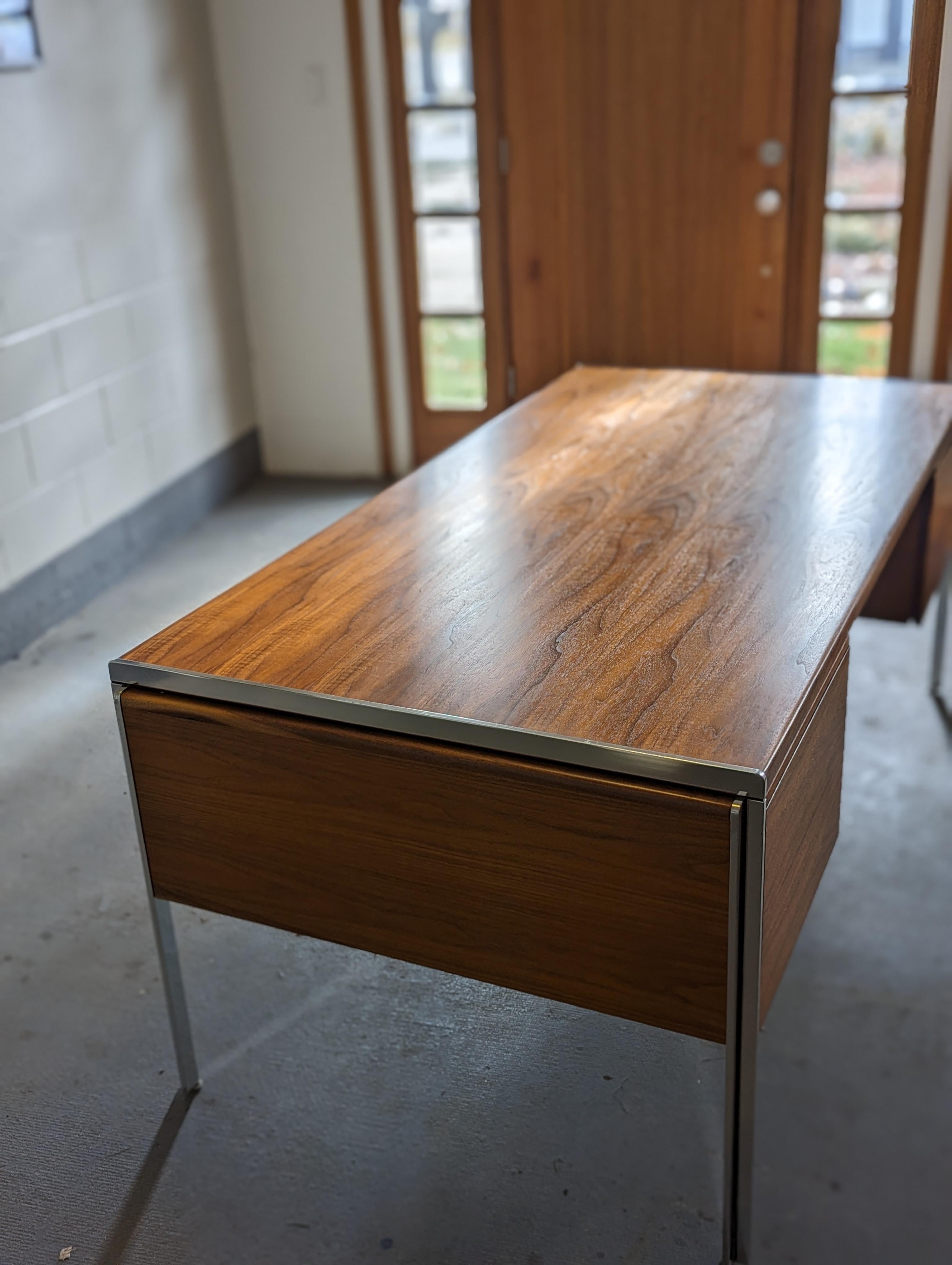 Stunning walnut color and figure present on this expansive executive desk designed by Alexis Yermakov for Stow Davis' 