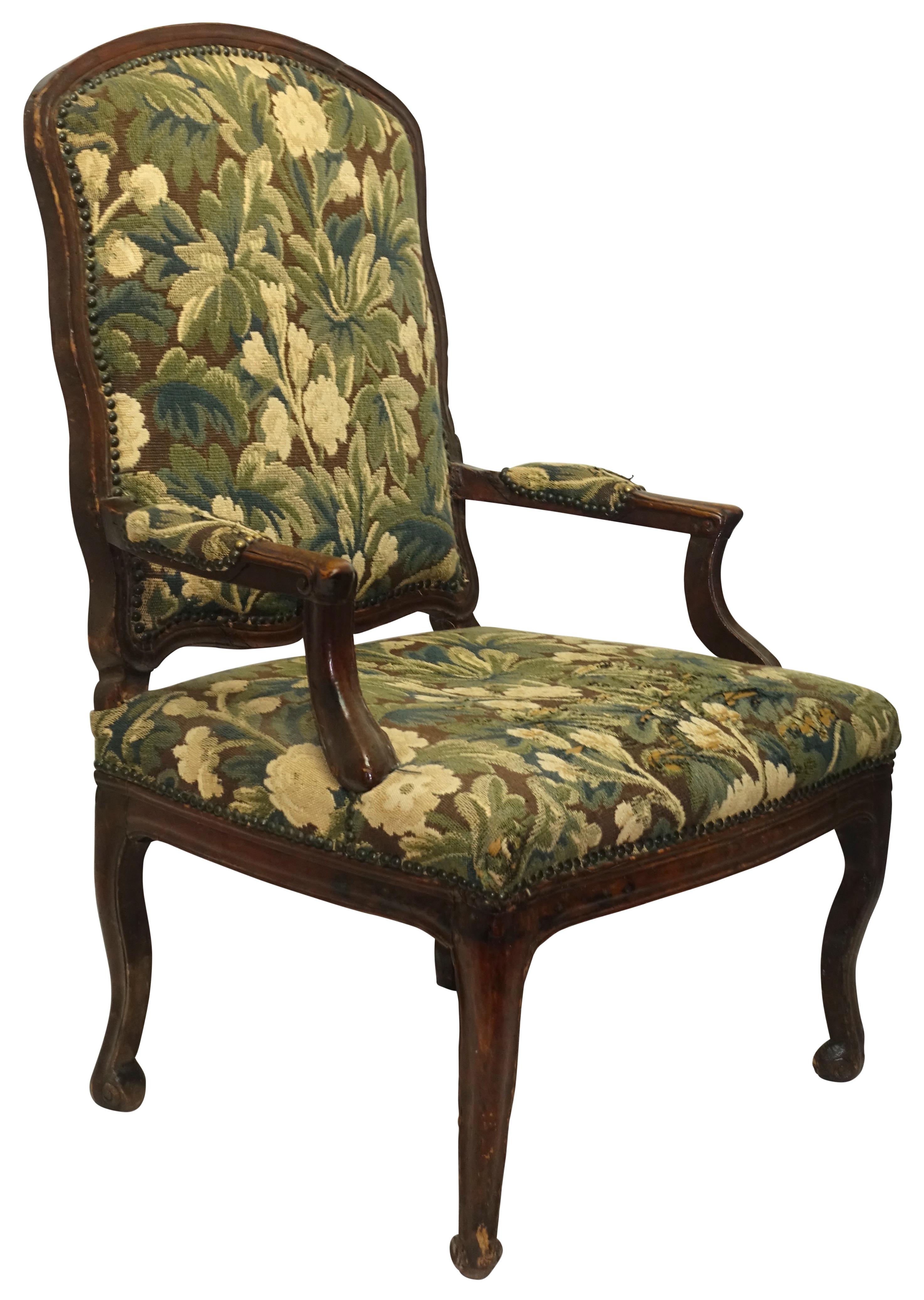 A large-scale carved walnut armchair with 19th century loomed tapestry upholstery. Chair is in very good condition, the upholstery is worn in areas, Italy, early to mid-18th century.