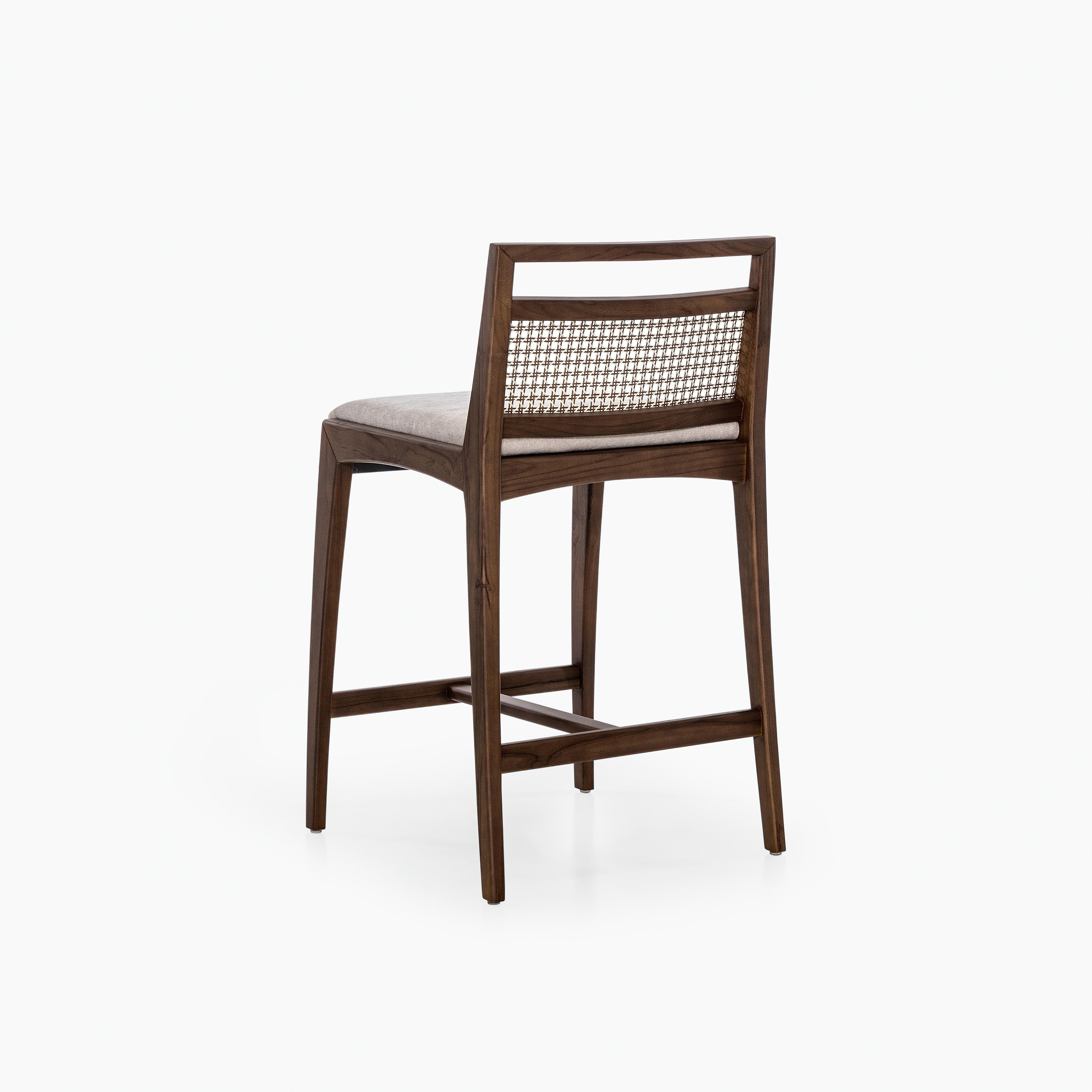 A Sotto counter stool designed by Uultis Studio with walnut finish, beige fabric and mixed light cane. *Please check availability prior to purchase*

The Sotto counter stool blends vintage charm with refined craftsmanship, making it a versatile
