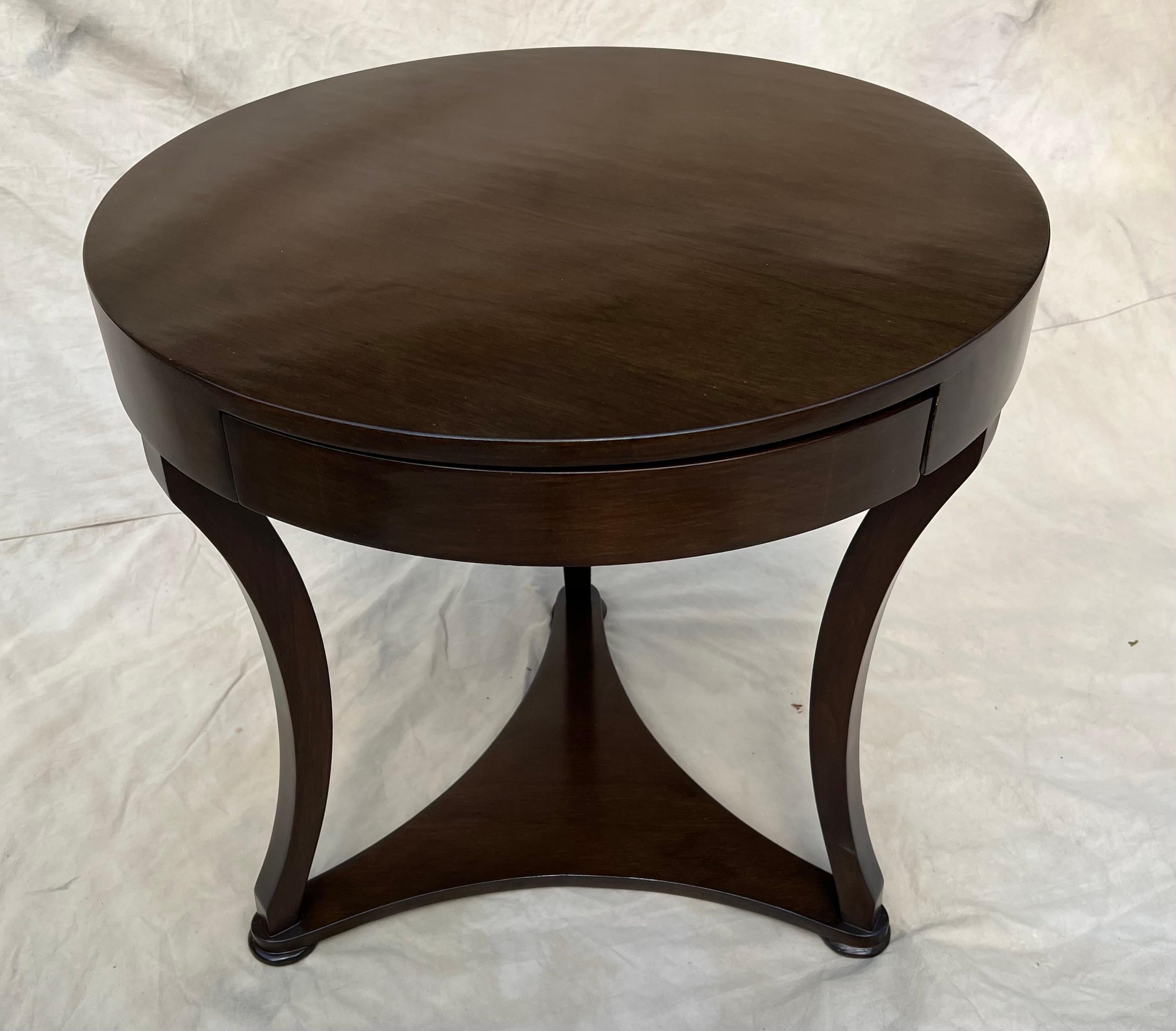 A walnut finish side table with drawer. The table is a wonderful side or bedside table. The finish is new and has no imperfections. We like the table without the drawer showing (turning the drawer to the back), however, if you need to store remotes