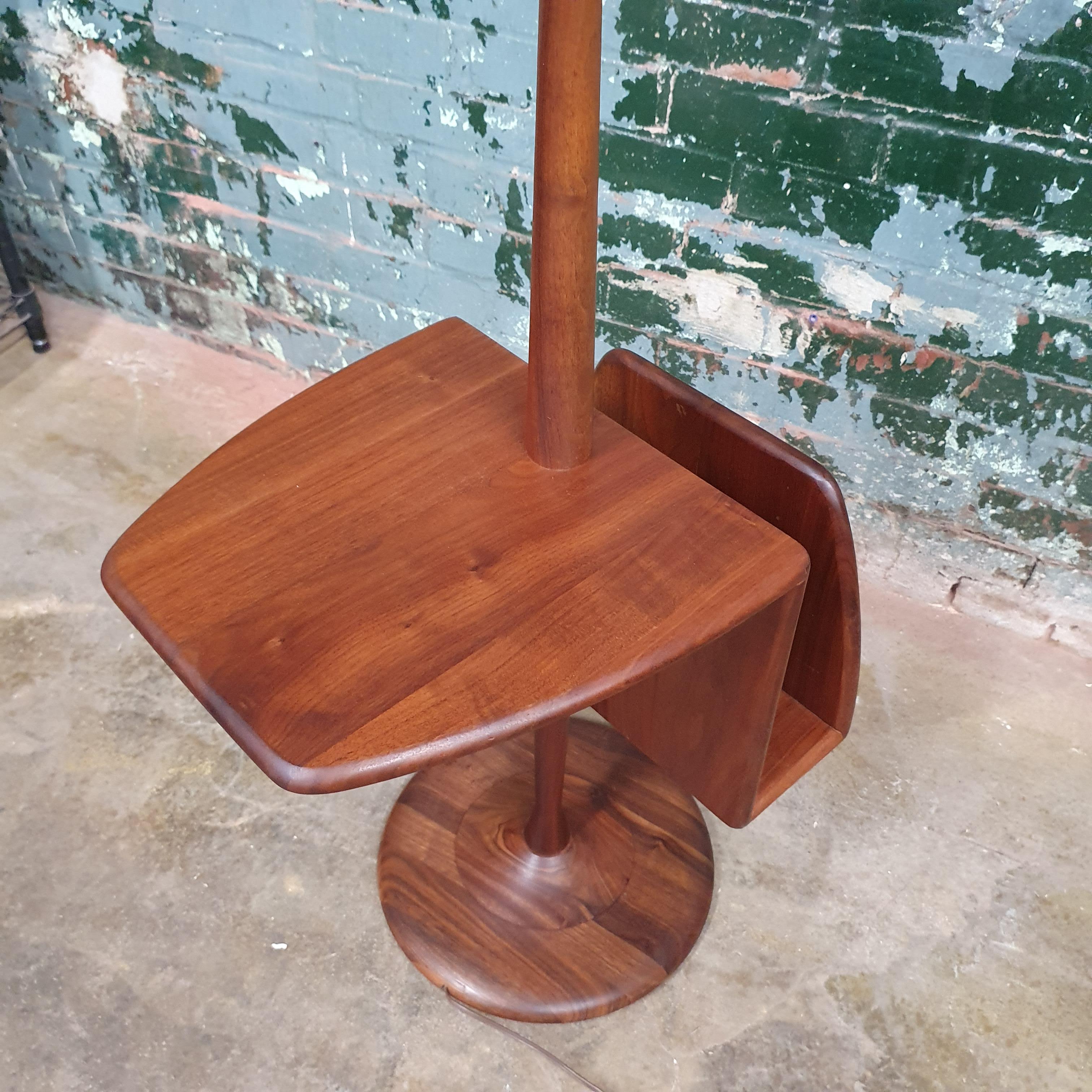 Beautiful walnut floor lamp by laurel lamp company. Featuring a solid walnut table with a magazine rack.