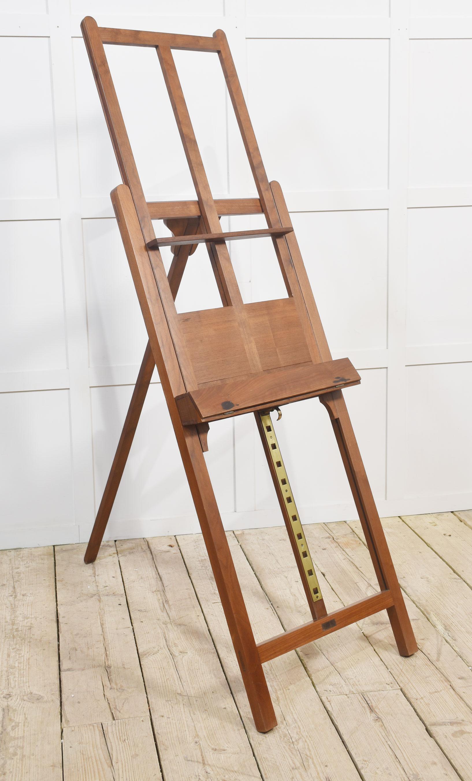 Walnut folding artists easel, the folding frame with a rise and fall shelf with a hinged fall front.
Dimensions
Height 75 Inches Adjustable
Width 24 Inches
Depth 31 Inches