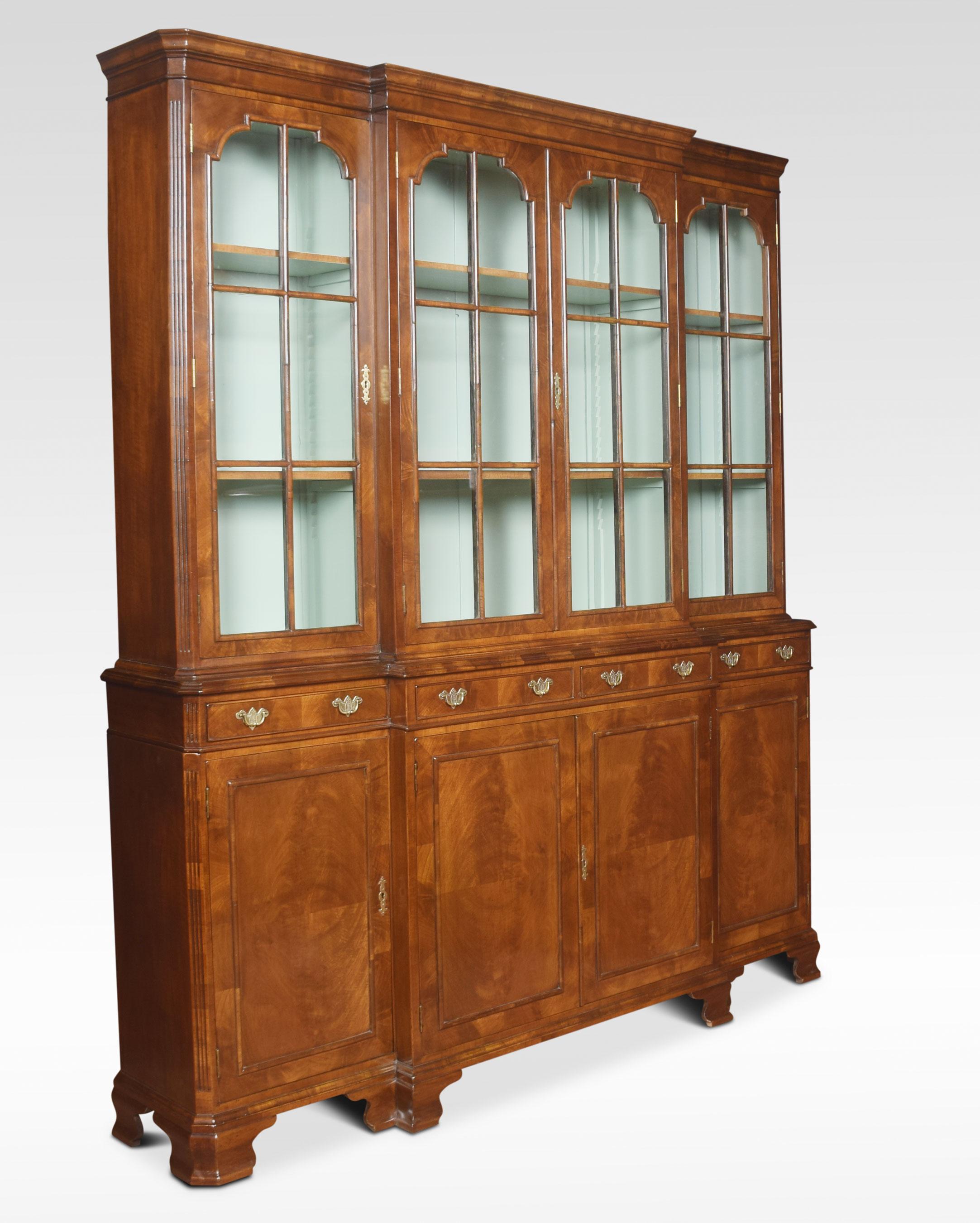 Queen Anne revival walnut four-door bookcase, the projecting cornice above, four large glazed doors opening to reveal an adjustable shelved interior. To the base Dimensions
Measures: Height 82.5 inches
Width 71.5 inches
Depth 15 inches.
