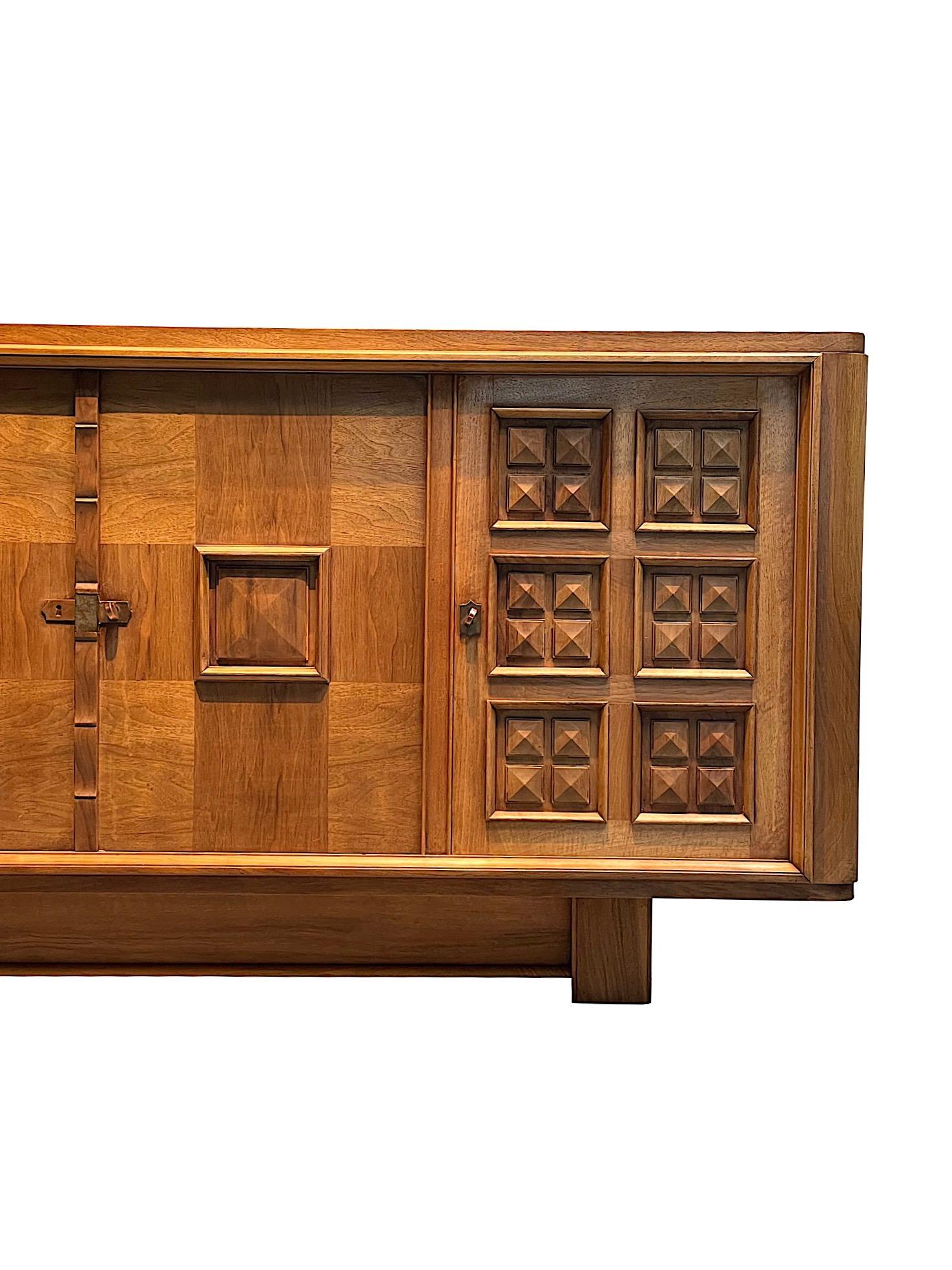 1940's French four door credenza in the style of Charles Dudouyt.
Two doors with decorative pyramid shaped raised panels.
Two doors and top with checkerboard design.
Walnut.
Three Interior shelves and two interior drawers.
ARRIVING AUGUST.
