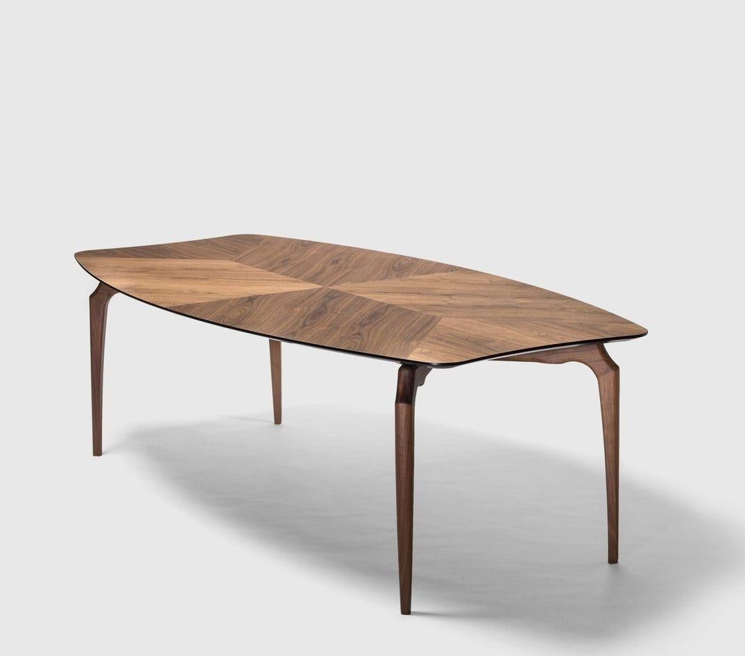 Walnut Gaulino table by Oscar Tusquets
Dimensions: D 120 x W 300 x H 74 cm 
Materials: Structure and legs in solid walnut wood. Top in MDF varnished walnut nature effect. The edges and the underside are lacquered in black.
Available in size 240