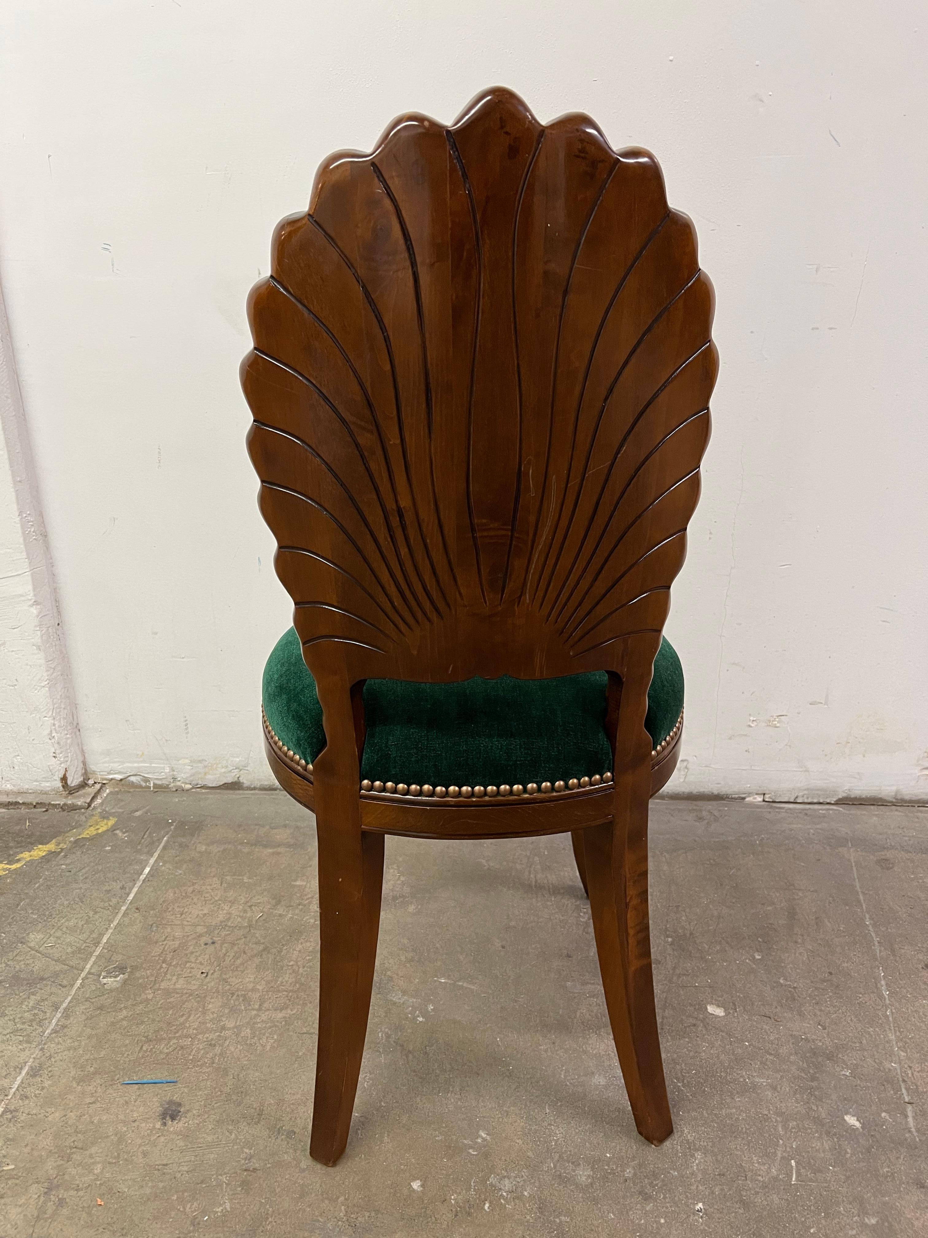 A walnut grotto style chair (or Shell Back Chair) with emerald green mohair upholstery detailed with antique brass nail heads. A lovely piece to be used as a sire chair or decorative piece. While in very good overall condition a scratch to the back,
