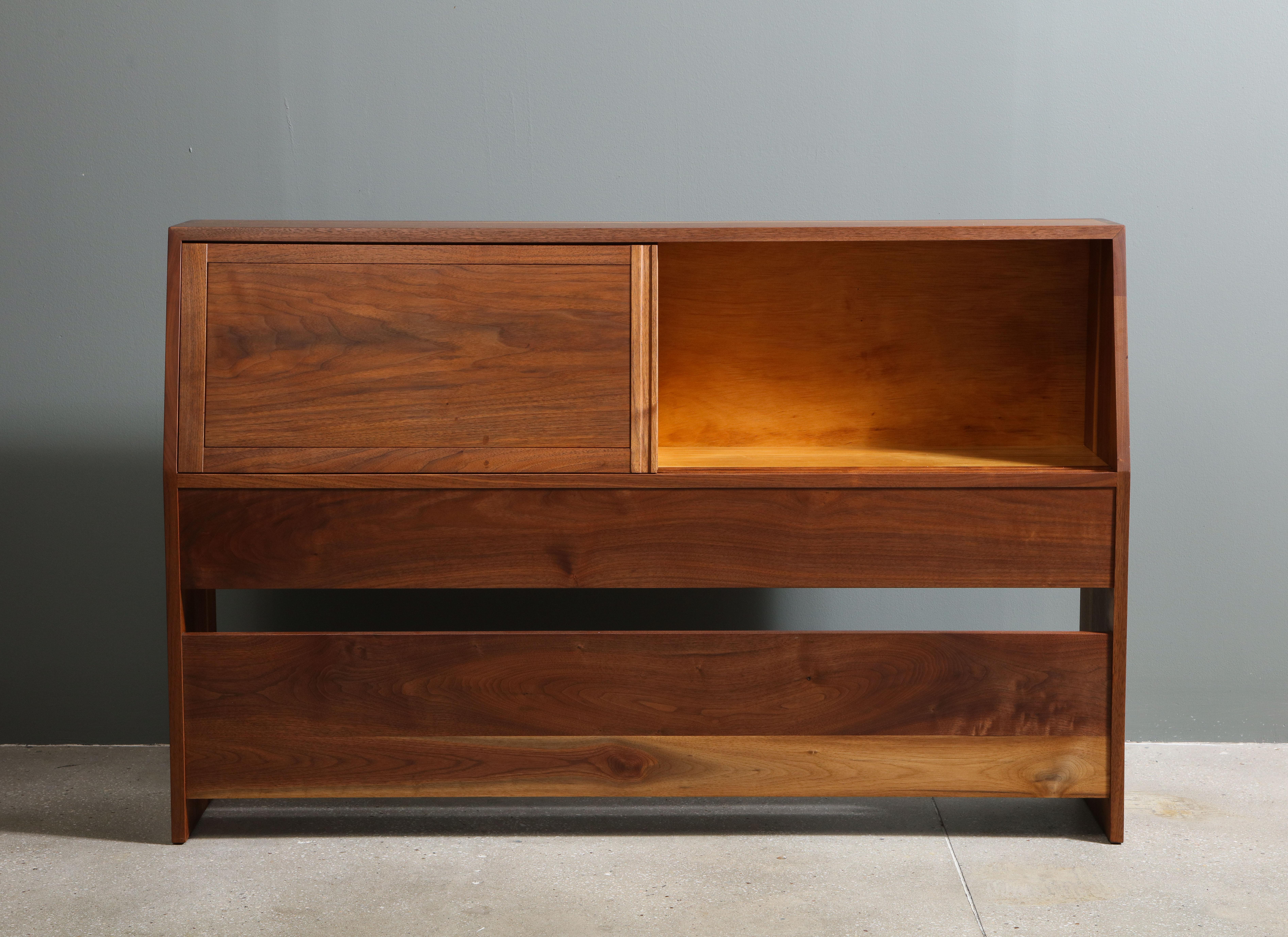 A full size, walnut headboard with dovetailed joinery and one sap streak. Two sliding doors opening to a storage compartment.  

Recently restored by Nakashima Studios.

Provenance includes all original purchase receipts and letter of authenticity