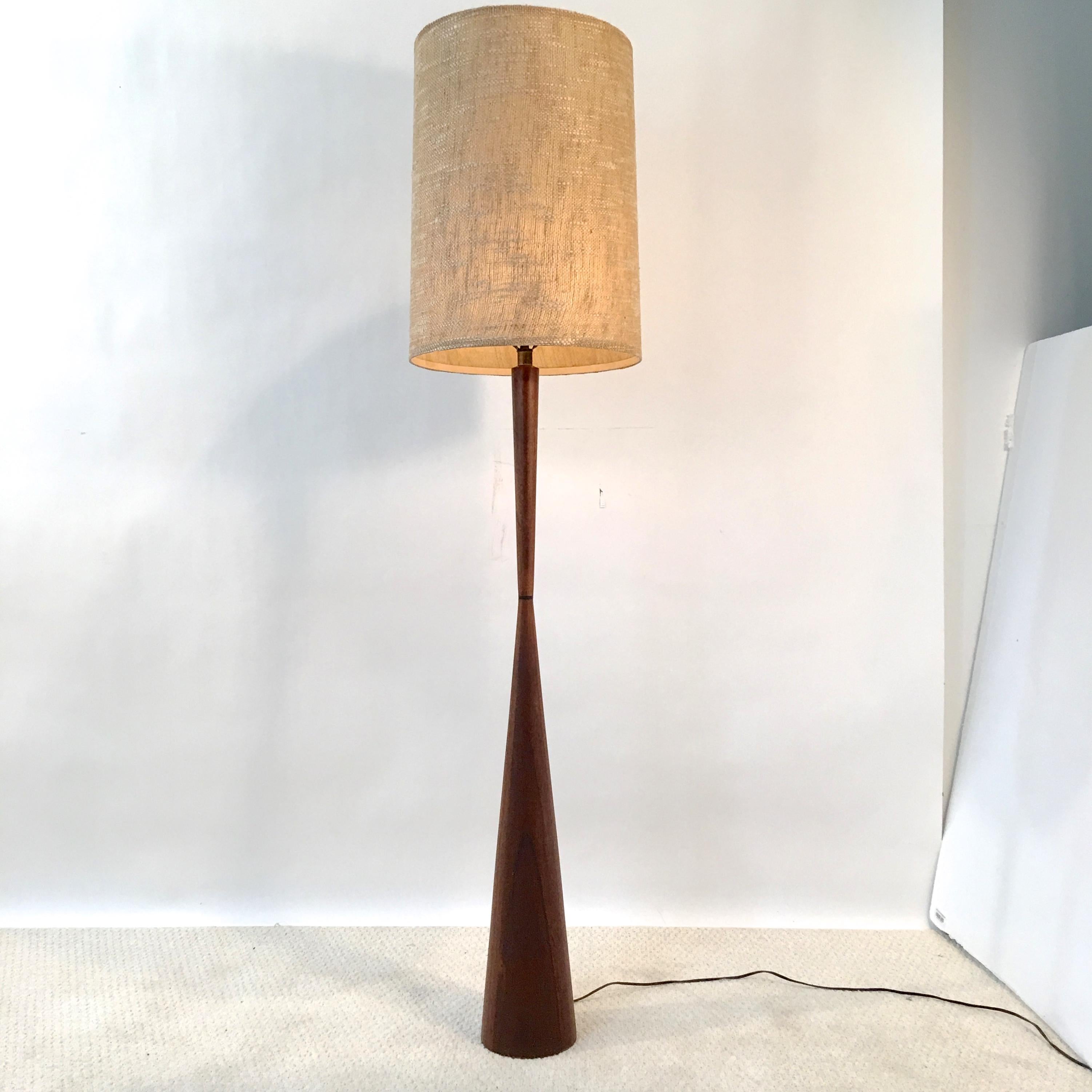 Walnut diabolo form floor lamp designed by Raymond Pfennig for Zina Lamp Co. in Northern California circa 1960. Original woven drum shade included. 
46