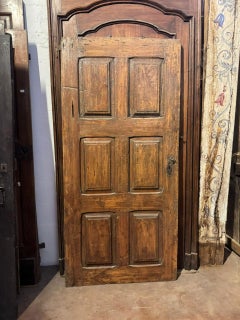 Walnut internal single door with six carved panels, Italy