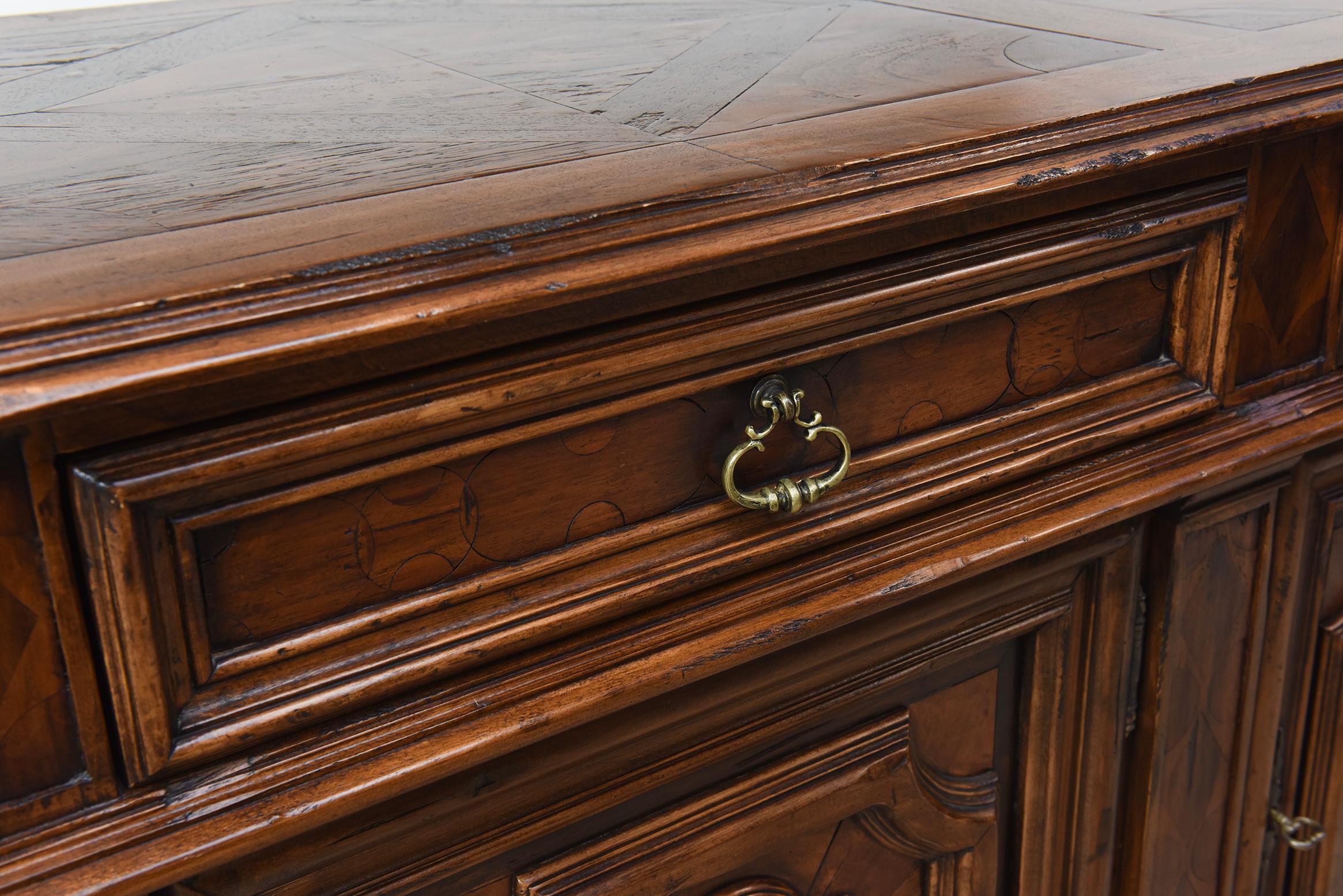 An exceptional Italian walnut (Jacaranda) sideboard by Bussandri, circa early 21st century, showcasing a refined blend of French Provincial and Brittany styling. The sideboard features three generously sized dovetailed drawers above three lower