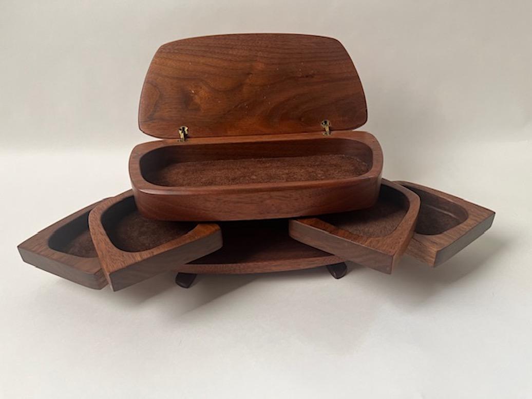 Walnut Jewelry Box 
Flip top with suede covered interior
4 swing out drawers