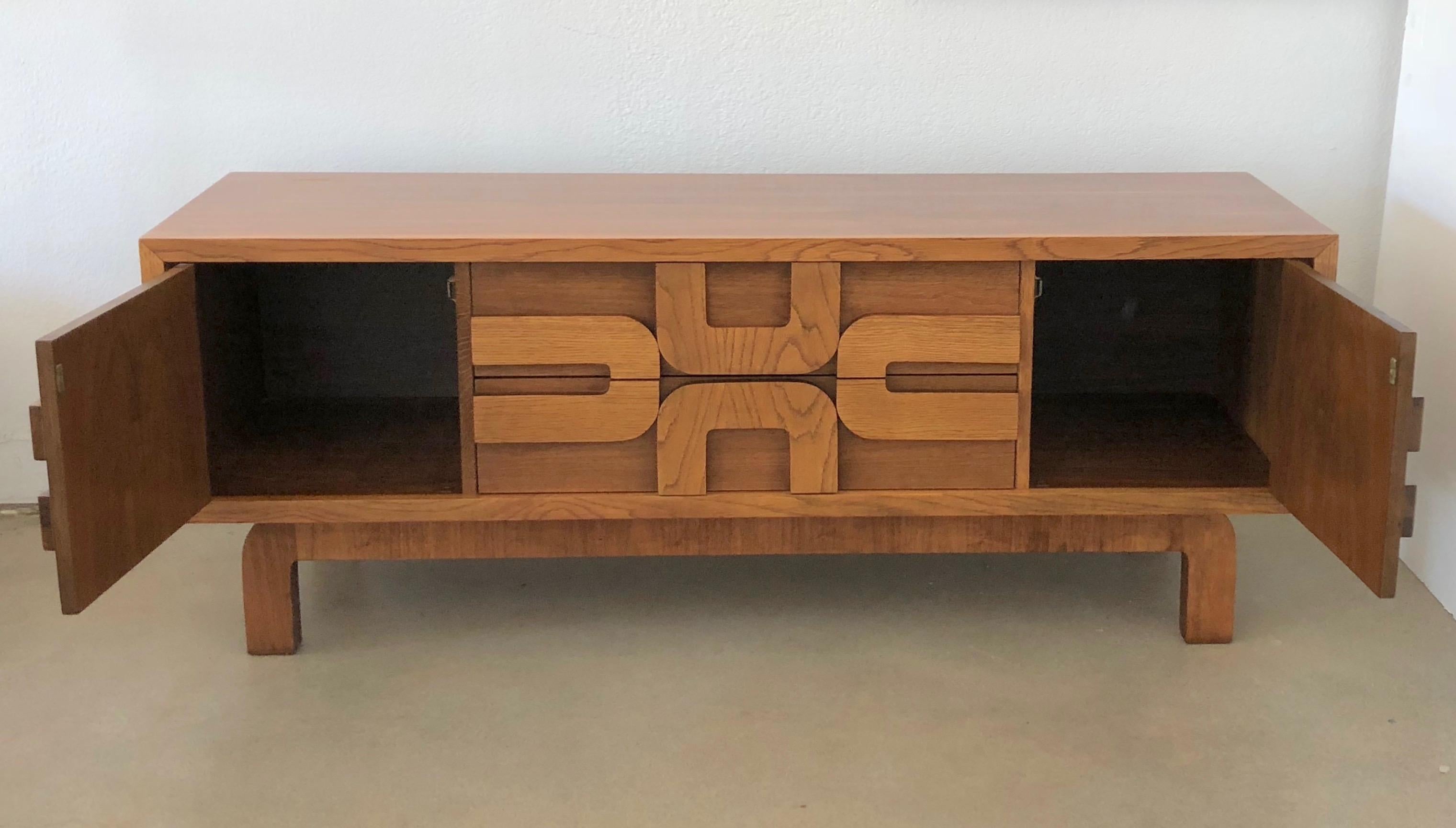 This low Brutalist Lane cabinet has a beautiful walnut grain. The scale and proportions of this piece work well for media storage, or behind a sofa or at the foot of a bed.
The cabinet retains its original paper tags. There are two doors on either
