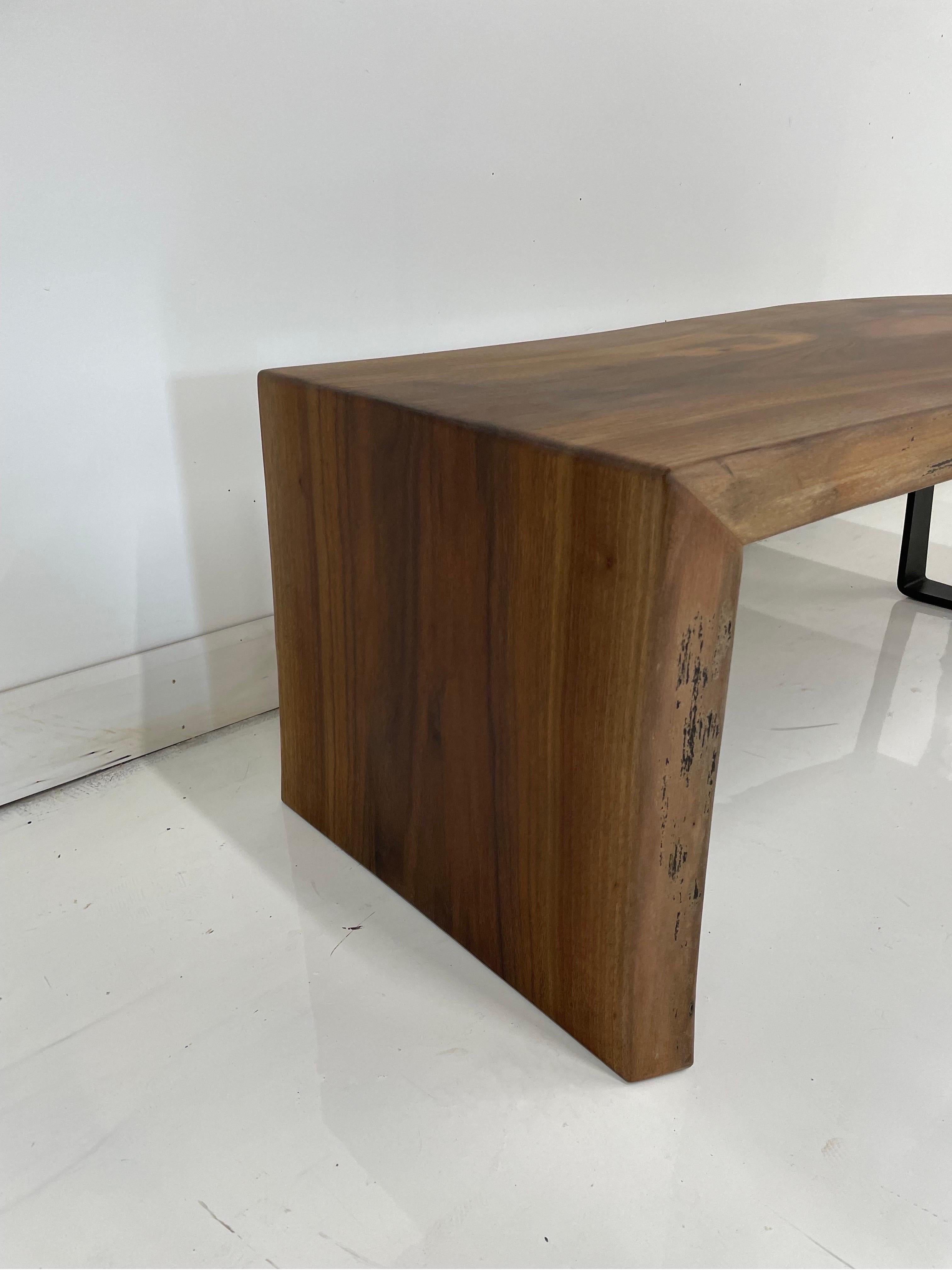 Single slab walnut live edge coffee table with waterfall leg. Starting out as a single slab of walnut, the waterfall leg was meticulously crafted to create a seamless look and have the grain flow over the top and into the leg. 

The opposite side