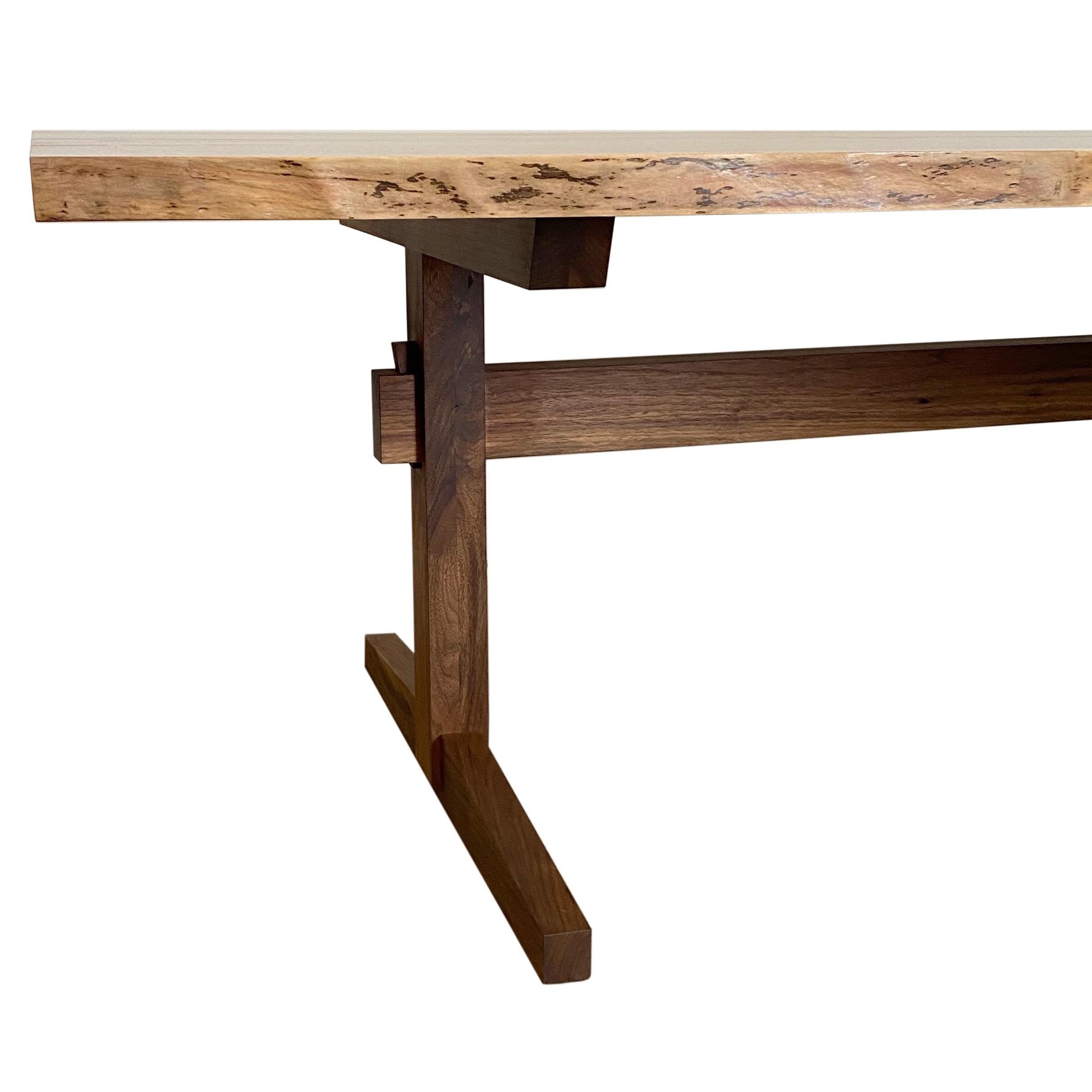 New York Heartwood's Sen Trestle table is inspired by Mid-Century Design, adding clean lines to a George Nakashima influenced base and butterflied split live-edge slab top. Constructed by hand using traditional joinery techniques including wedged