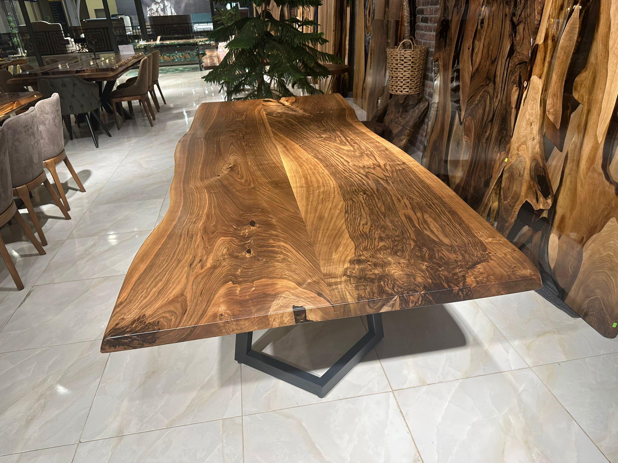 Custom Walnut Live Edge Kitchen Table 

This table is made of Walnut Wood. The grains and texture of the wood describe what a natural walnut woods looks like.
It can be used as a dining table or as a conference table. Suitable for indoor use.

All