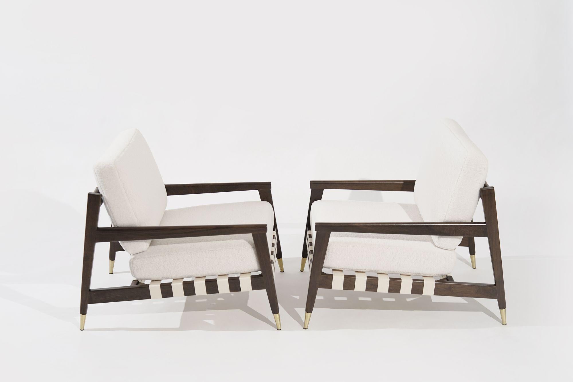 A set of meticulously restored lounge chairs, designed by the eminent Edmond J. Spence in the 1950s for Urban-Aire Group, now revived to their former glory by Stamford Modern. These iconic chairs embody the epitome of mid-century design, offering a