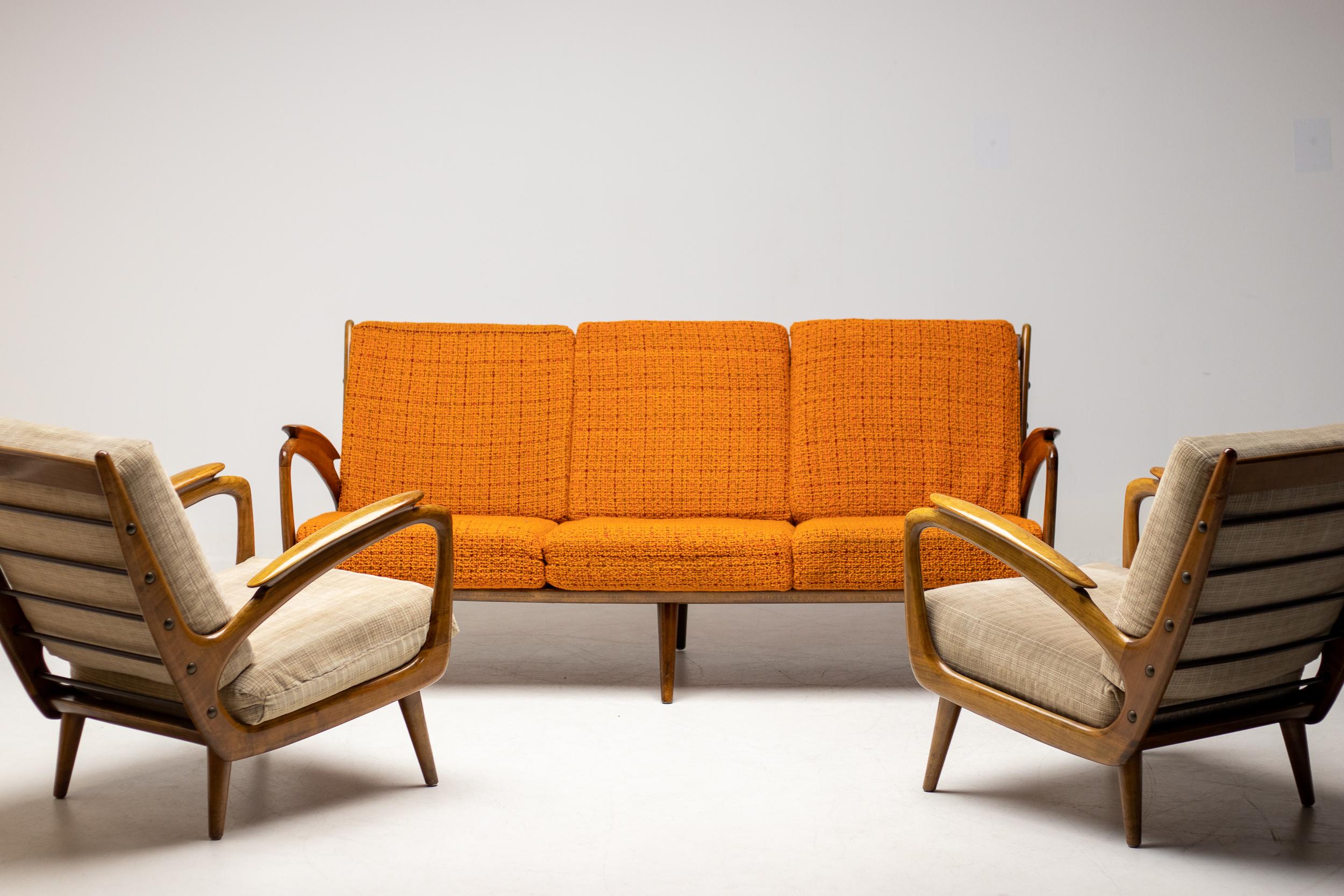 A set of organic shaped walnut armchairs made circa 1950 by Sprij Meubelen in Vlaardingen, The Netherlands.  Mid-Century Modern design and the self-evident quality of that era. 
The boxspring seats provide excellent comfort. Exquisite organically