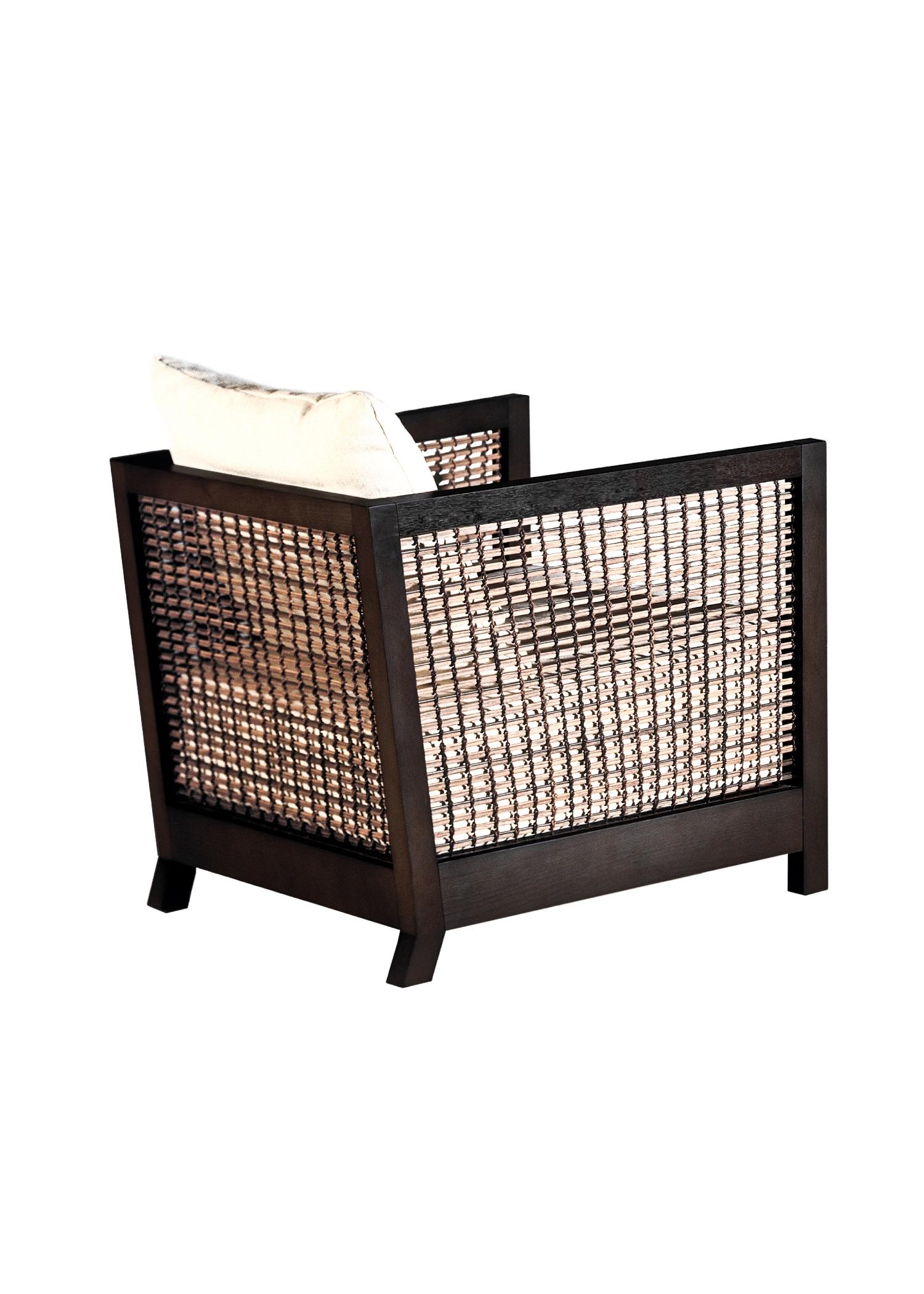 Walnut lowback suzy wong easy armchair by Kenneth Cobonpue.
Materials: Lampakanai, rattan, walnut. 
Also available in maple.
Dimensions: 76 cm x 71 cm x H 64 cm

Woven panels create a feeling of intimacy as you and your guests indulge in