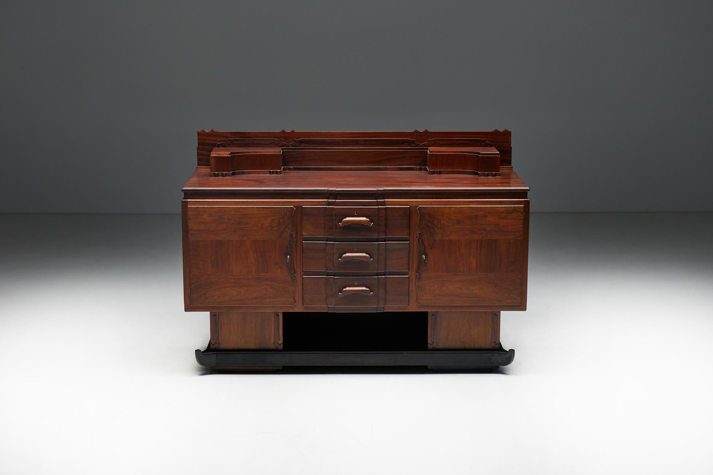 Amsterdam School Credenza, Arts & Crafts; Credenza; Walnut; Mahogany; Oriental inspired; The Netherlands; 1920s;

Walnut and mahogany Amsterdam School credenza, a true testament to the unparalleled craftsmanship and design of the era. This cabinet