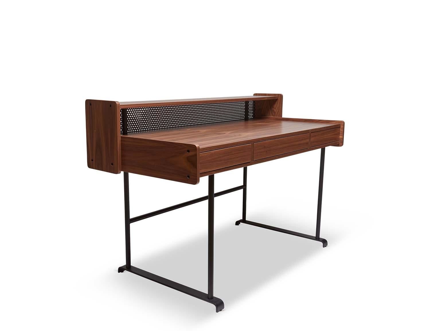 The Maker's desk is made of American walnut or white oak and has three push-to-open drawers. The case rests on a matte black powder-coated base, and features perforated steel detail on the back. Shown here in Natural Walnut.

The Lawson-Fenning