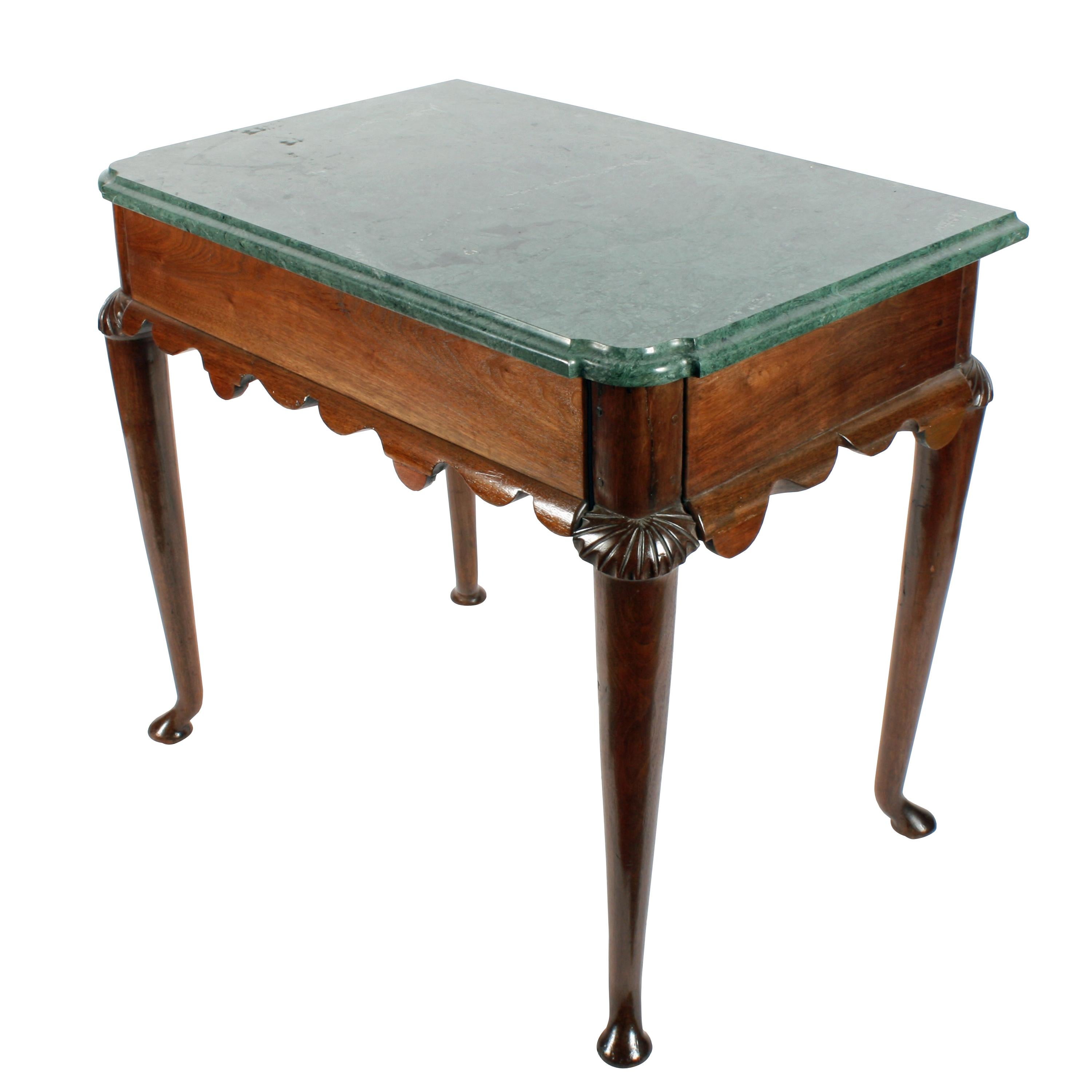 Walnut marble-top console table


A middle of the 18th century solid walnut console table with a shaped green marble top.

The table has four long tapering turned legs with unusual kick out pad feet and carved knees.

The frieze between the