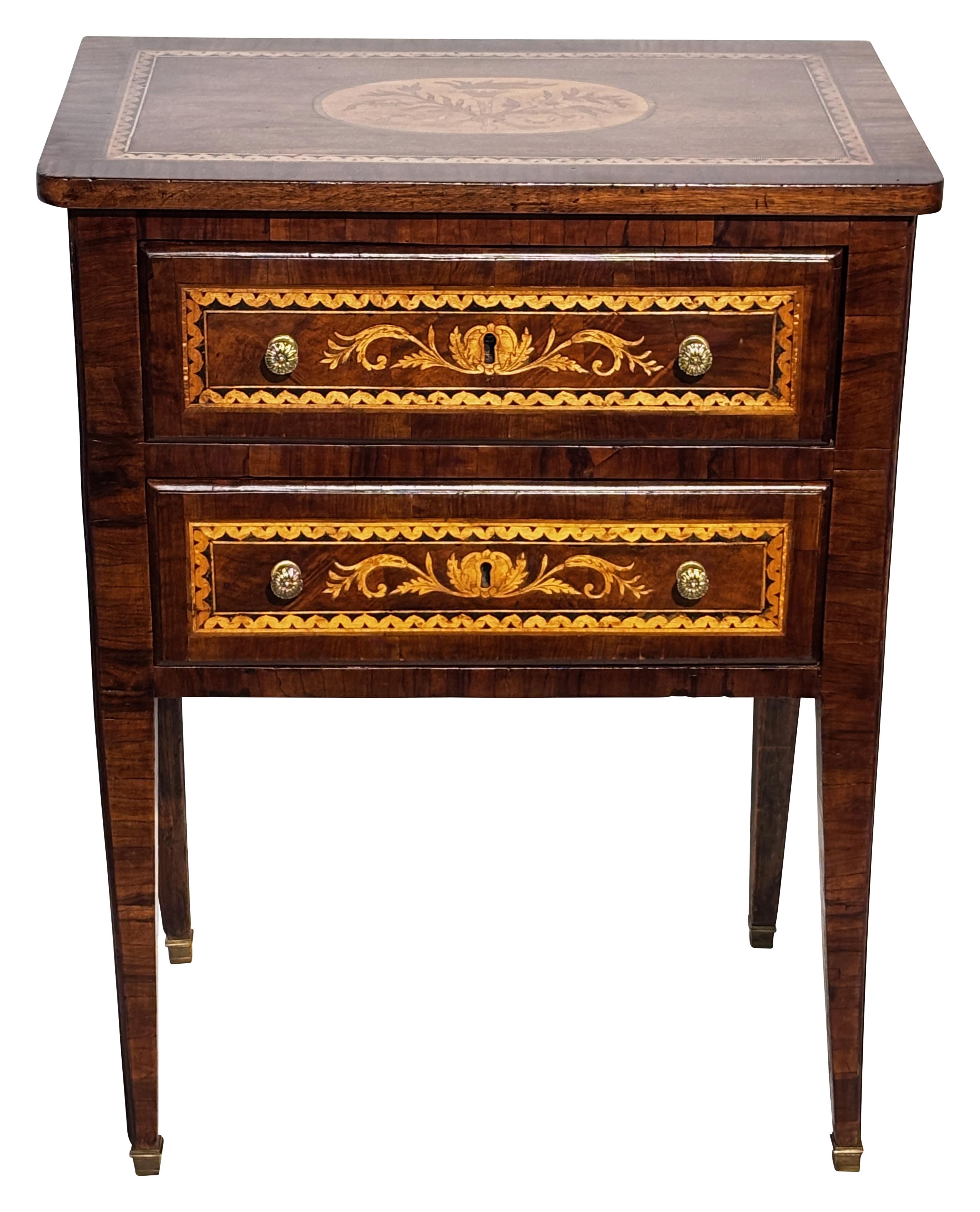 A small two-drawer walnut side table with exceptional marquetry inlaid design, and having wonderful presence and style.
Recently refinished and conditioned.
In remarkable antique condition, sturdy and sound with smooth working drawers.
Italy, 18th