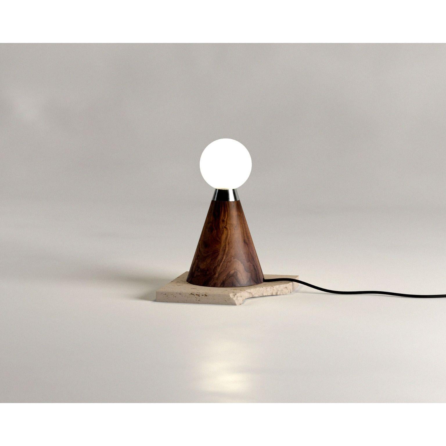 Mercurio Lamp Walnut by Siete Studio
Dimensions: D 20 x W 20 x H 36 cm.
Materials: Walnut, hand-blown glass.

Mercurio is a sculptural table lamp characterized by its balanced geometric form and simplistic appearance. The base references totemic