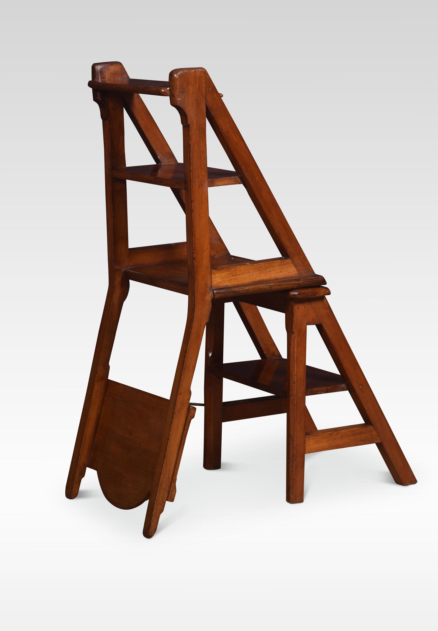 19th century walnut metamorphic chair, the shaped back with central circular carved detail. Above the solid seat, raised up on square supports united by stretchers. The chair opens into a sturdy set of Library steps.

Dimensions:
Height 34 inches